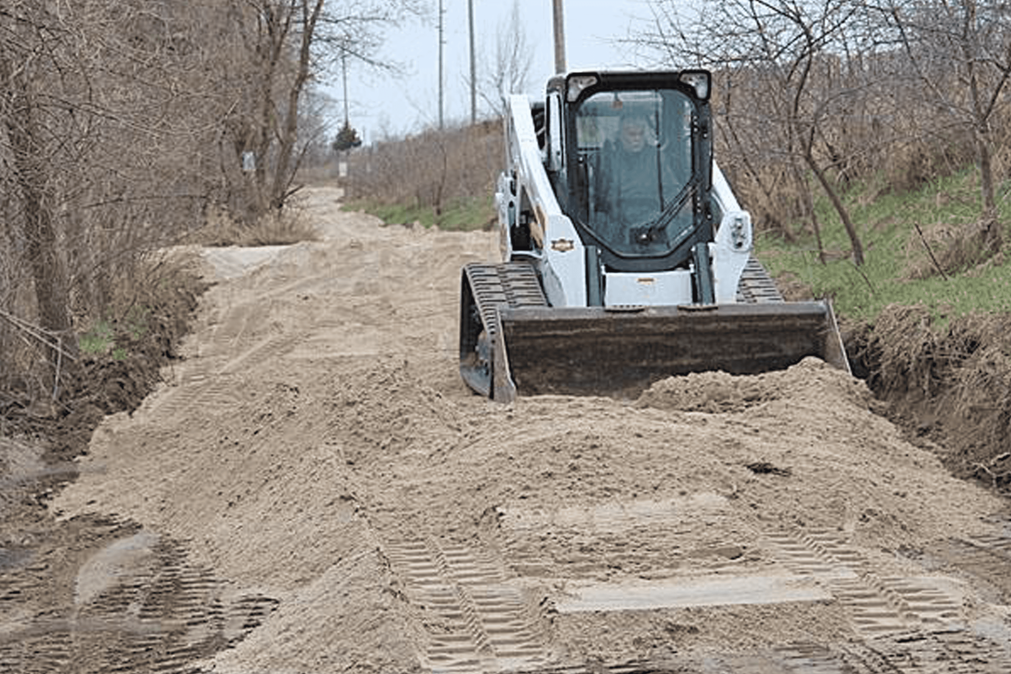 Nick's Lawn Care skid loader work on a residential property