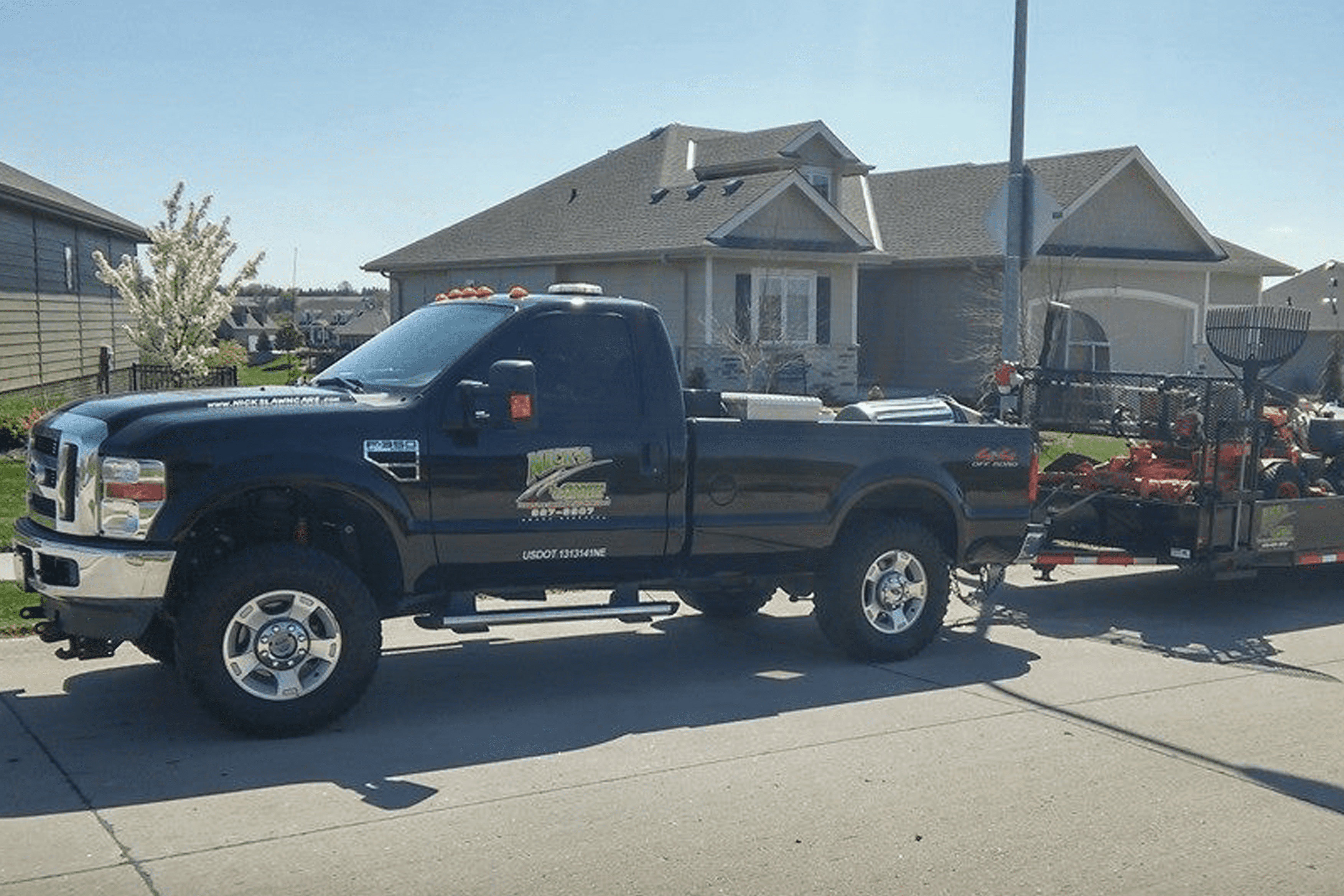Nick's Lawn Care team mowing a residential lawn in Omaha, NE