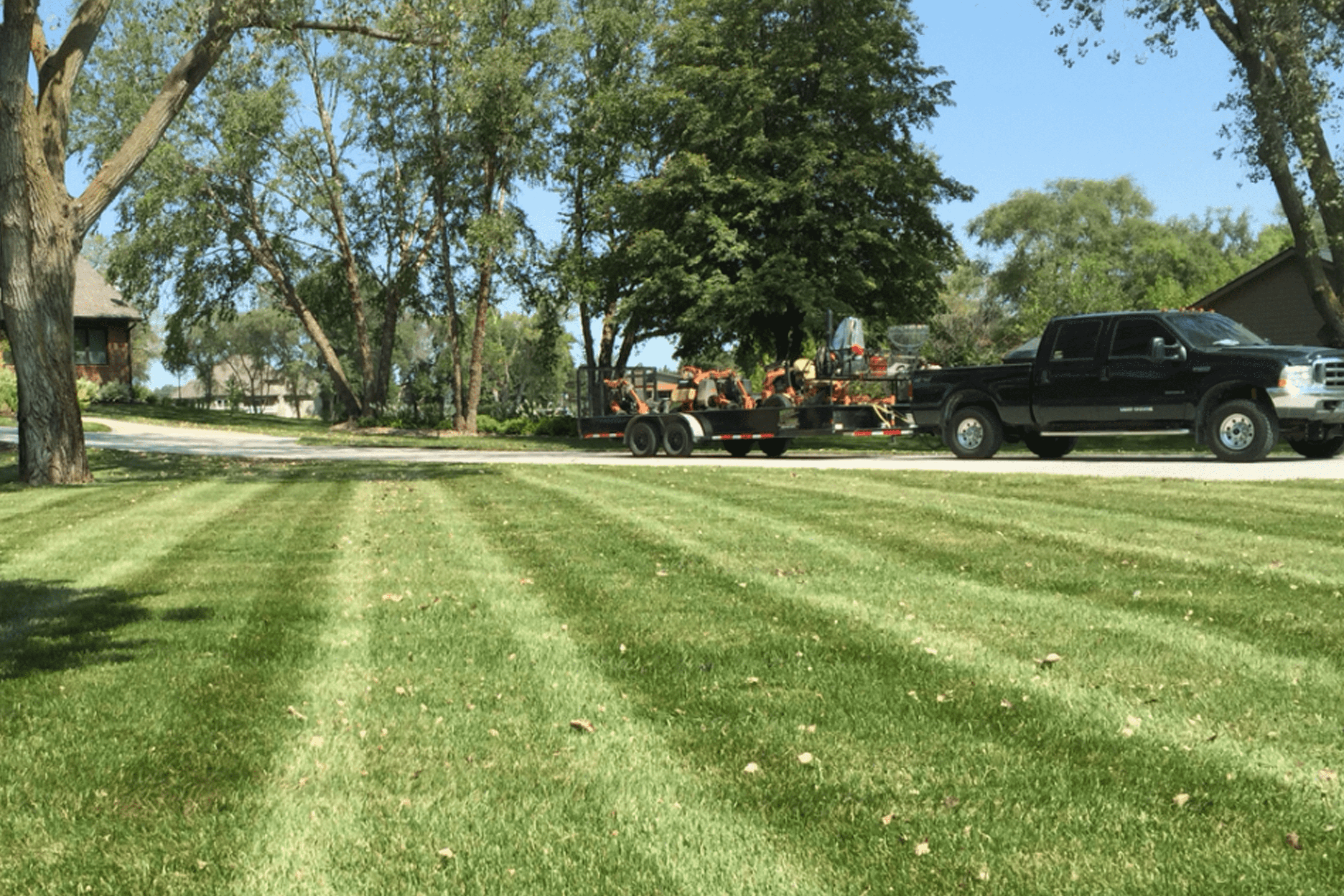 Nick's Lawn Care crew mowing a residential yard
