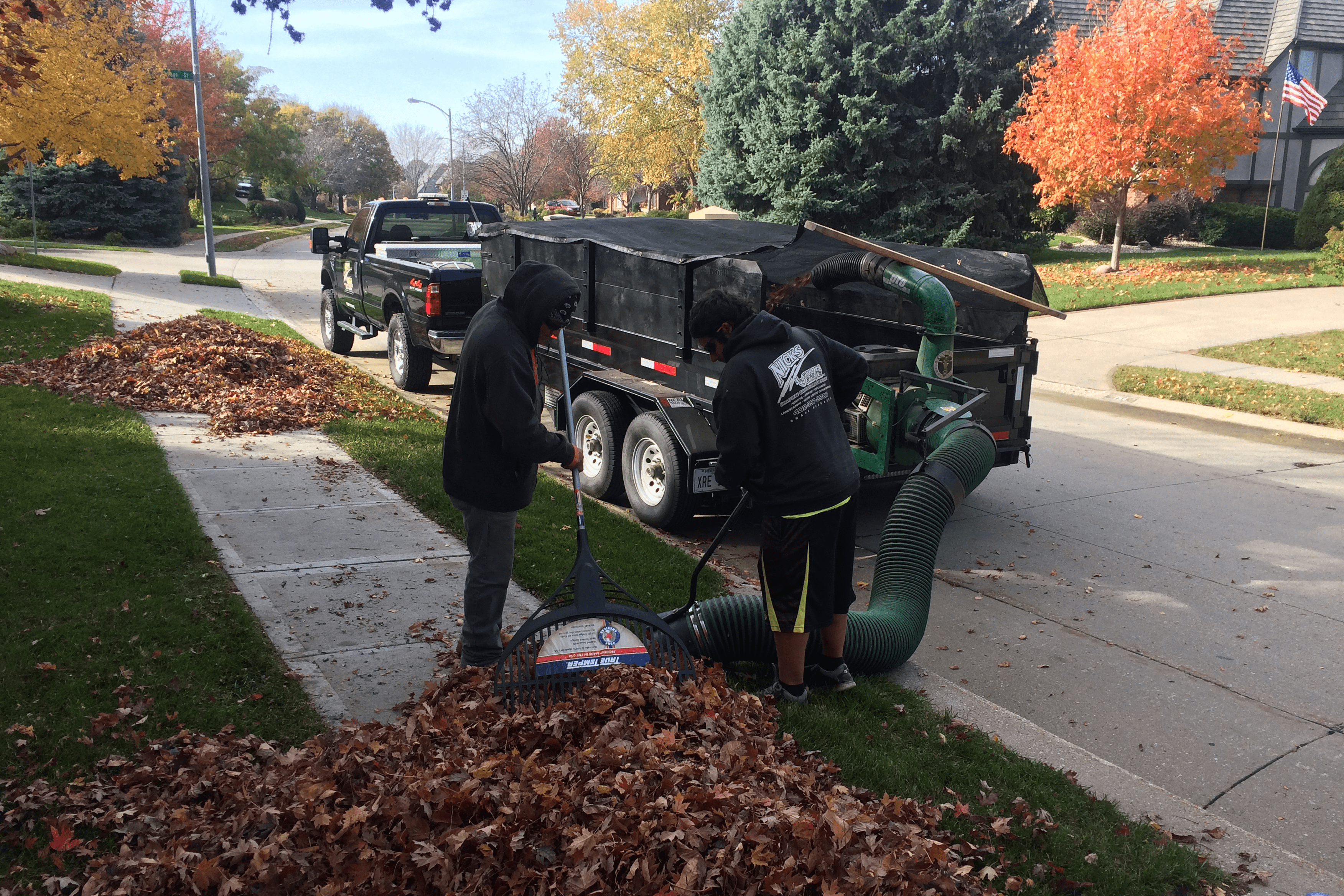 Nick's Lawn Care crew performing a seasonal yard clean-up