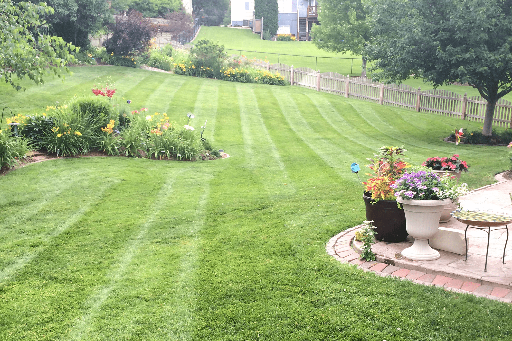 Nick's Lawn Care crew trimming and maintaining a property