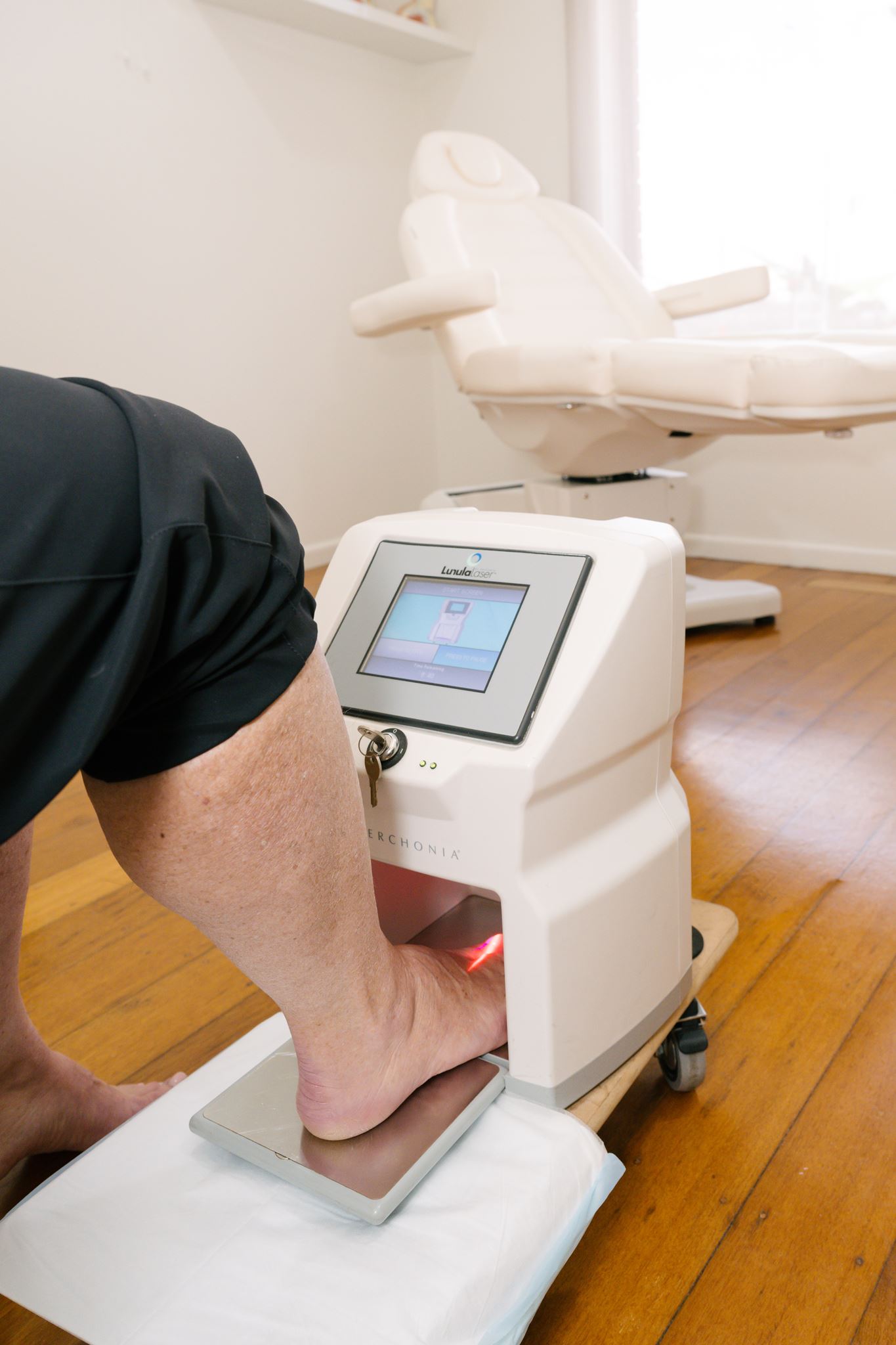 Podiatrist administering Lunula Laser treatment