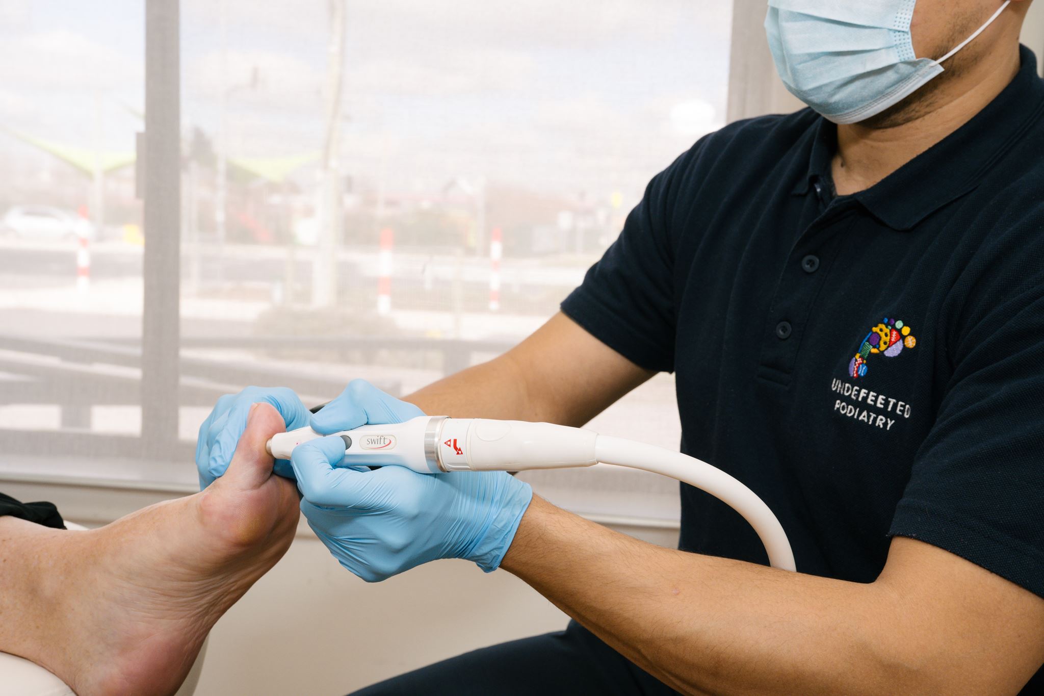 Podiatrist administering Swift treatment