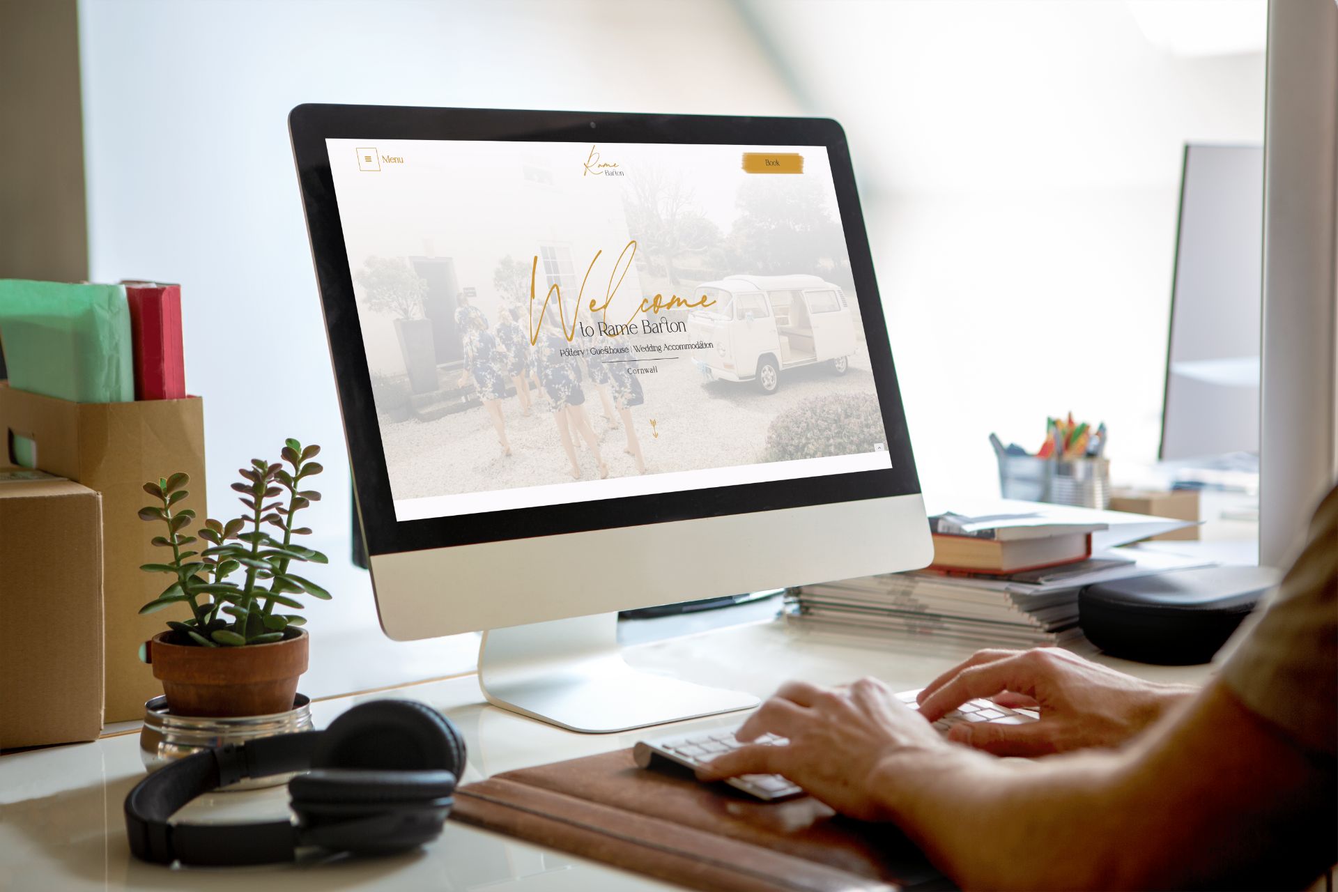 Man working on a Holiday Let Website on an iMac computer
