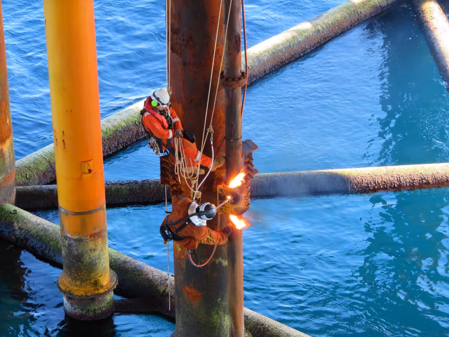 Rope access is a vital part of many offshore decommissioning projects. In this case the caissons are cut with blow torches while the mechanic is using rope access.