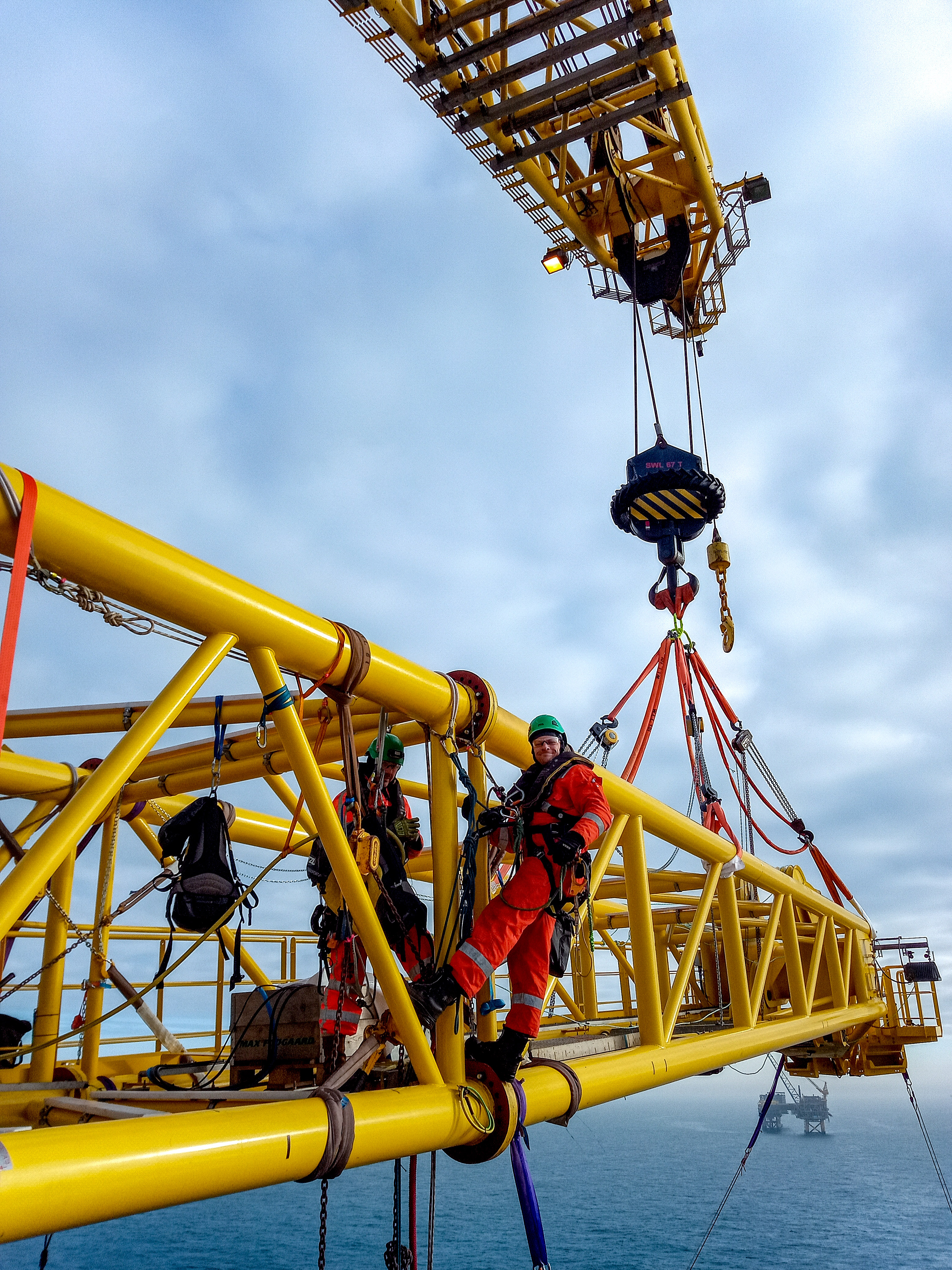 Rope access technicians at work on a crane boom replacement