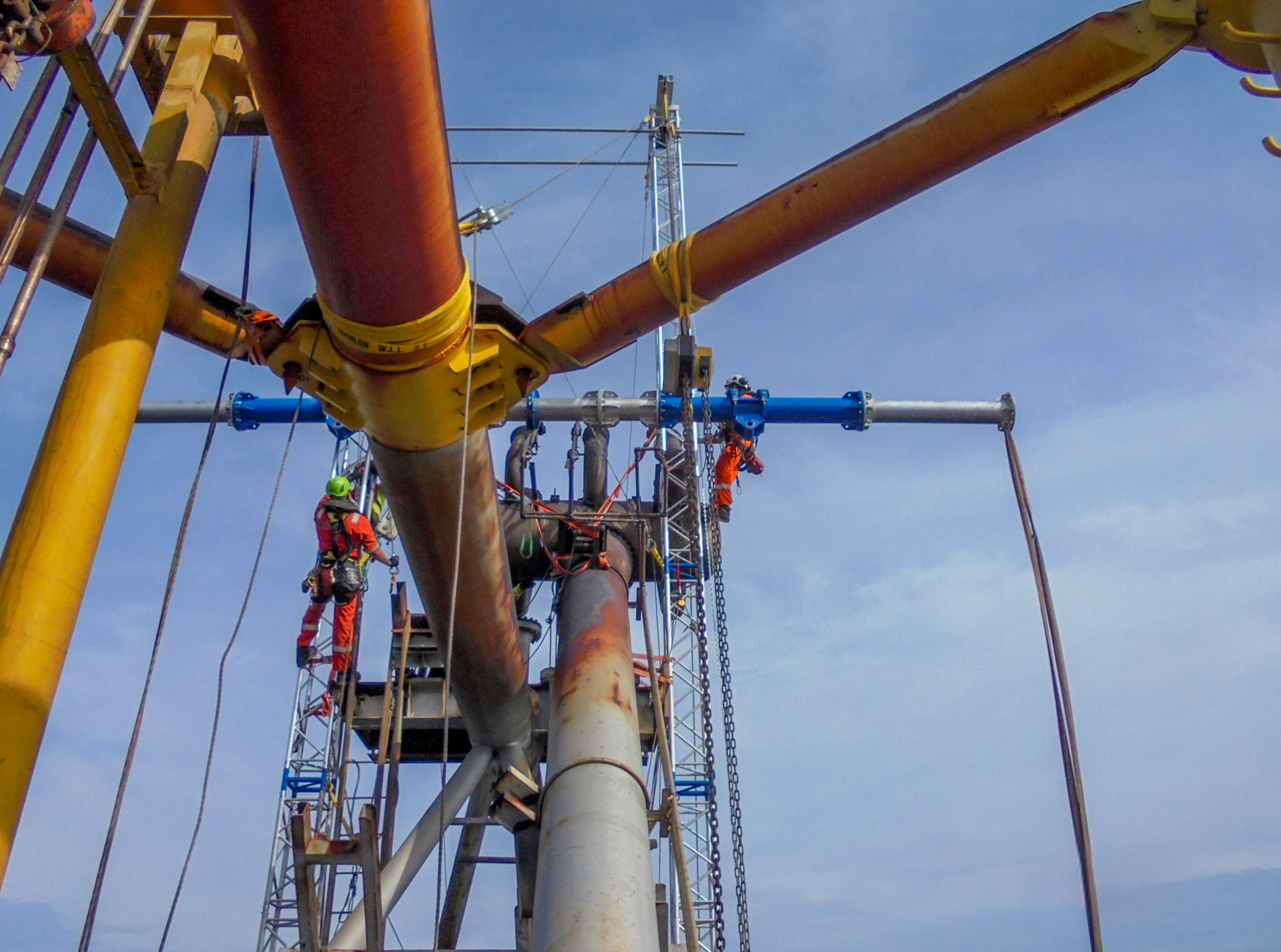 Rope access technicians building the modular lifting structure to replace a flare tip
