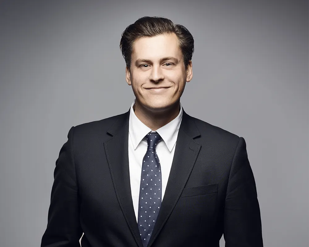 Pair of black work boots hanging in the air in an industrial setting