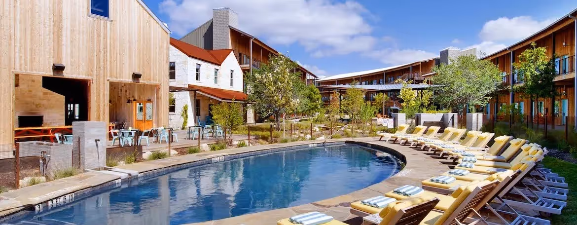 Lone Star Court is completed with landscaped courtyards, an outdoor pool, and live music events for a memorable stay.