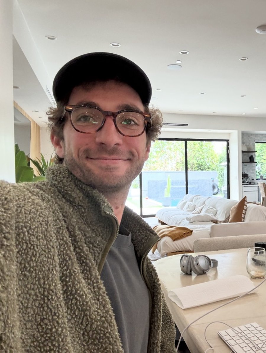 Thomas Mazimann working from a sunlit living room