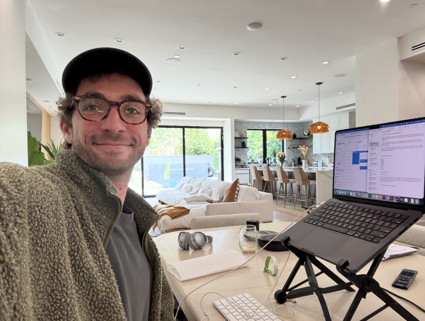 Thomas at his desk with a laptop, smiling