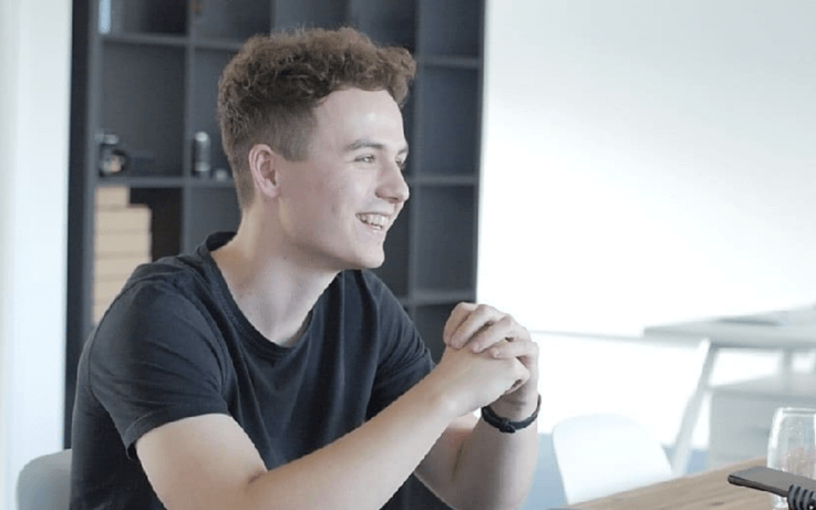 Side angle of man sitting down and laughing 