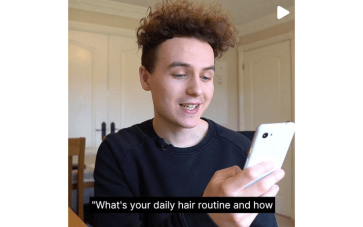 Man holding phone with subtitles on screen