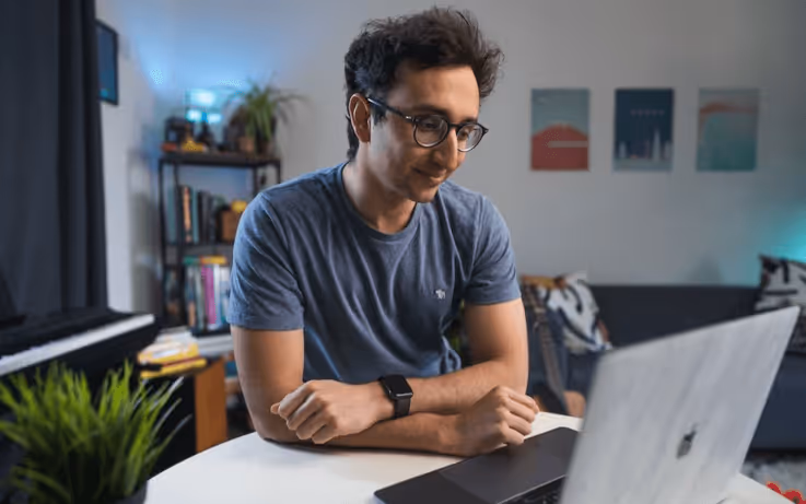 Man looking at computer and smiling