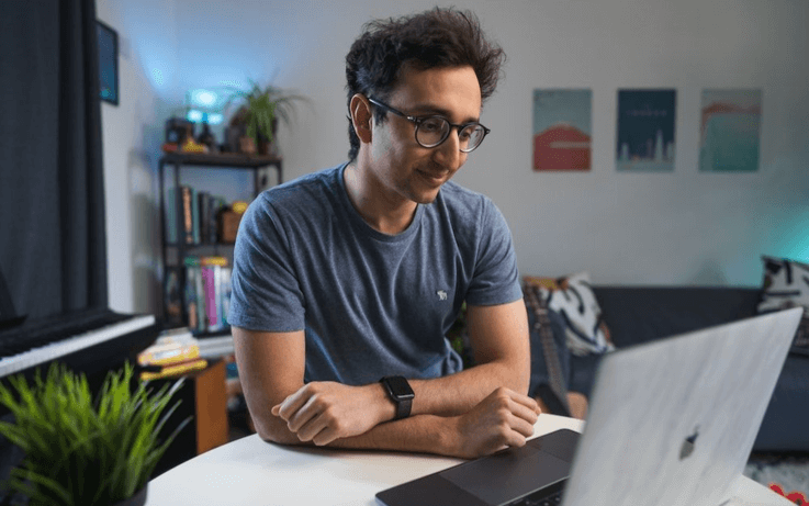 Man looking at computer and smiling