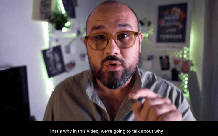 man speaking and pointing to camera with english subtitles on screen