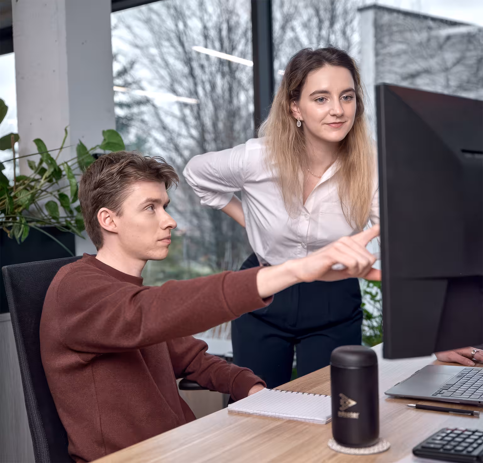 Adopter team members engaged in a collaborative climate tech marketing discussion in a bright modern office setting