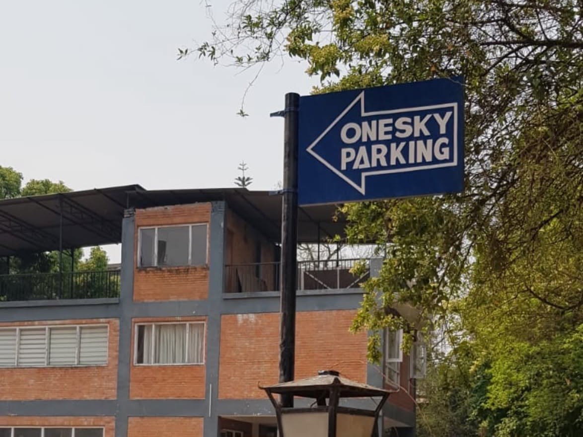 Signposted OneSky car park on a separate lot behind the building