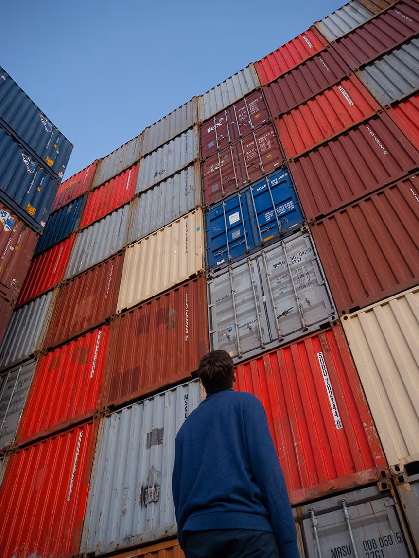 Man looking at ship containers image