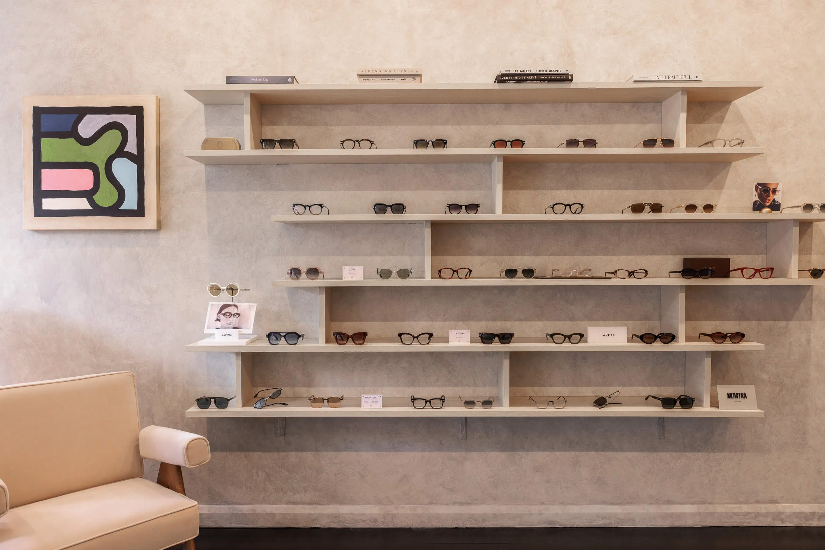 Alternate angle of the tortoiseshell sunglasses on marble plinth, emphasizing frame curvature and craftsmanship. The natural lighting highlights the rich amber hues of the lenses and acetate frame | EDG Studios