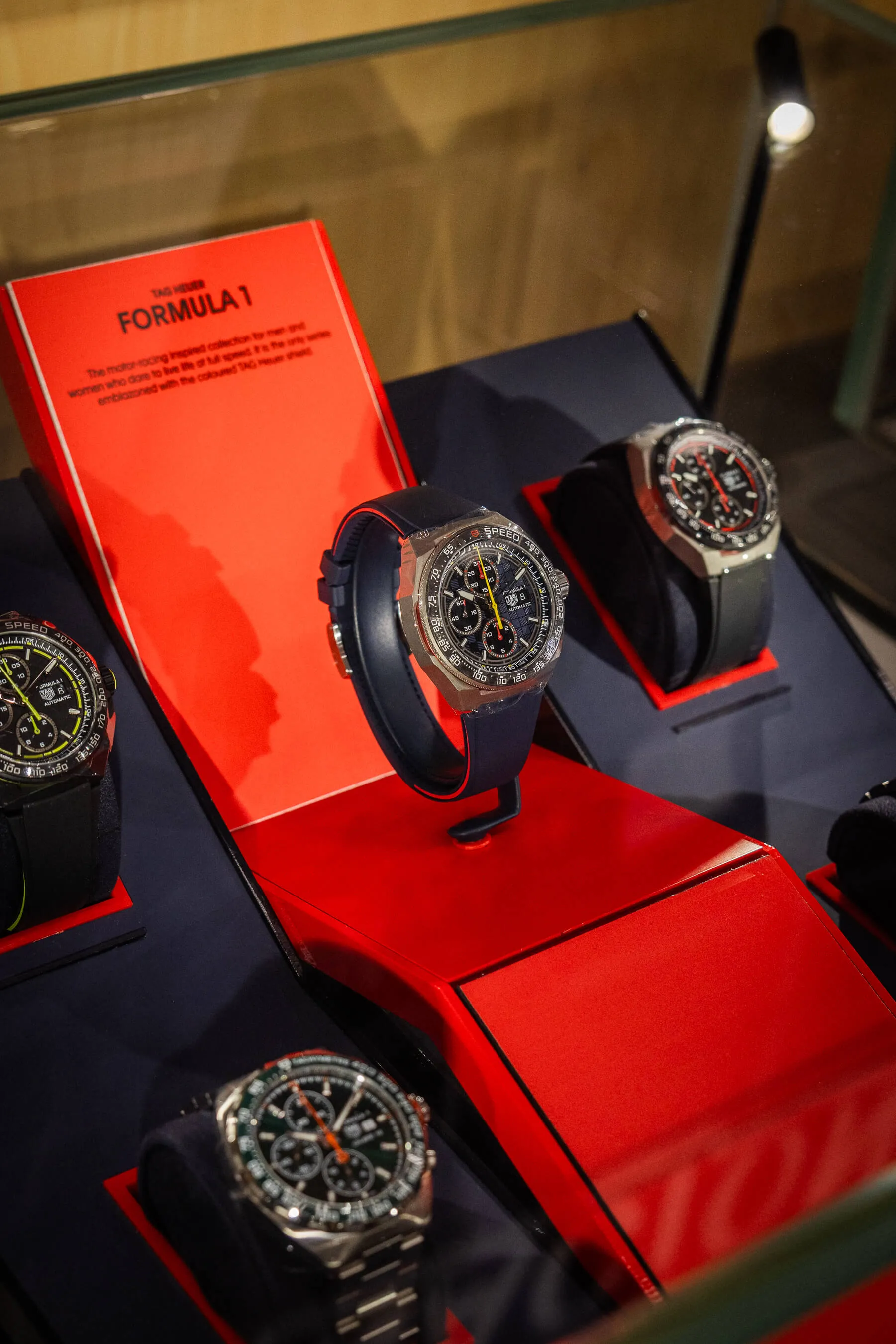 Display case of TAG Heuer Formula 1 watches, highlighting bold designs and racing-inspired details under bright spotlighting | EDG Studios