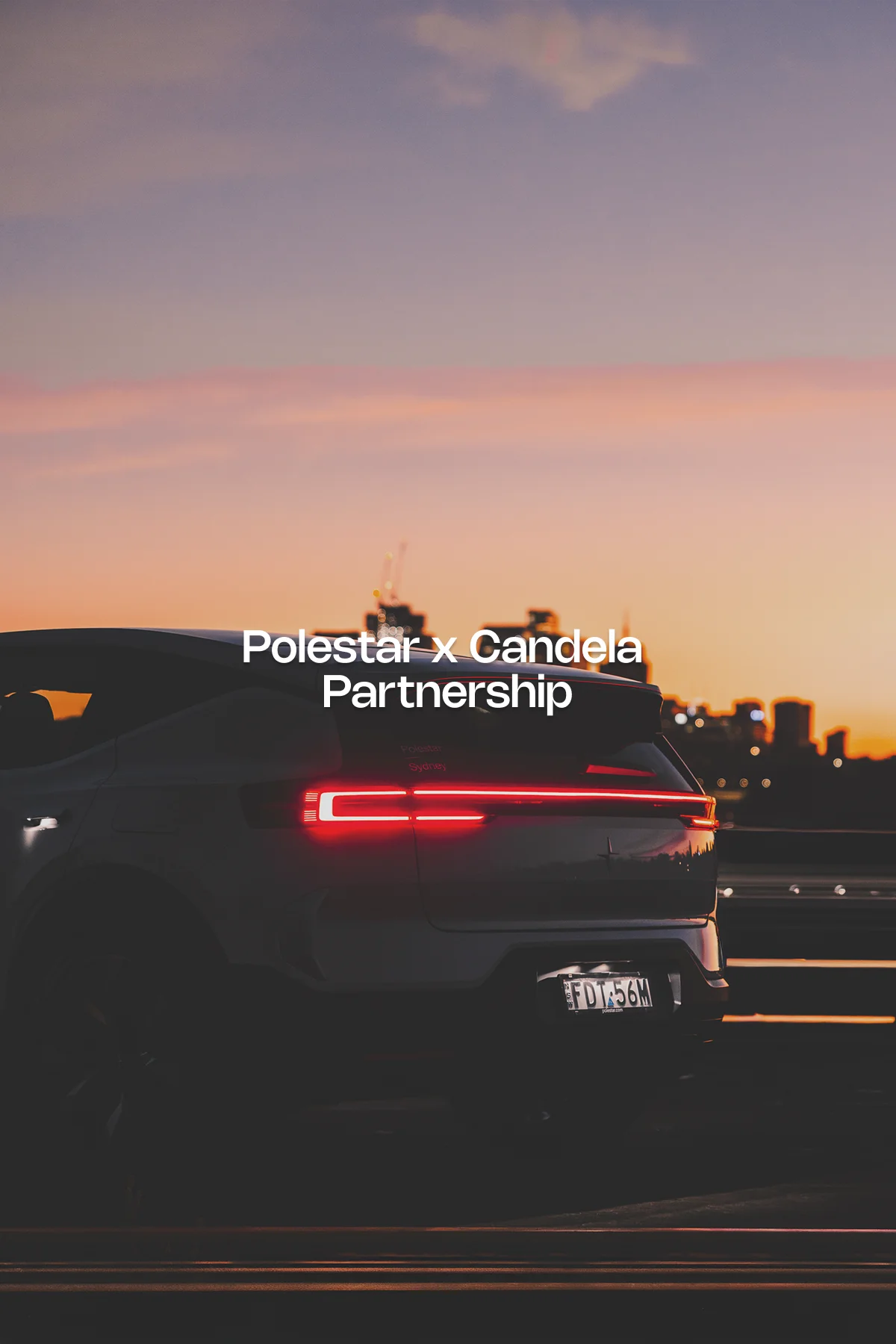 Rear view of a Polestar 2 electric vehicle with tail lights glowing at sunset, photographed by Eugene David Grey for the Polestar x Candela campaign in Sydney.