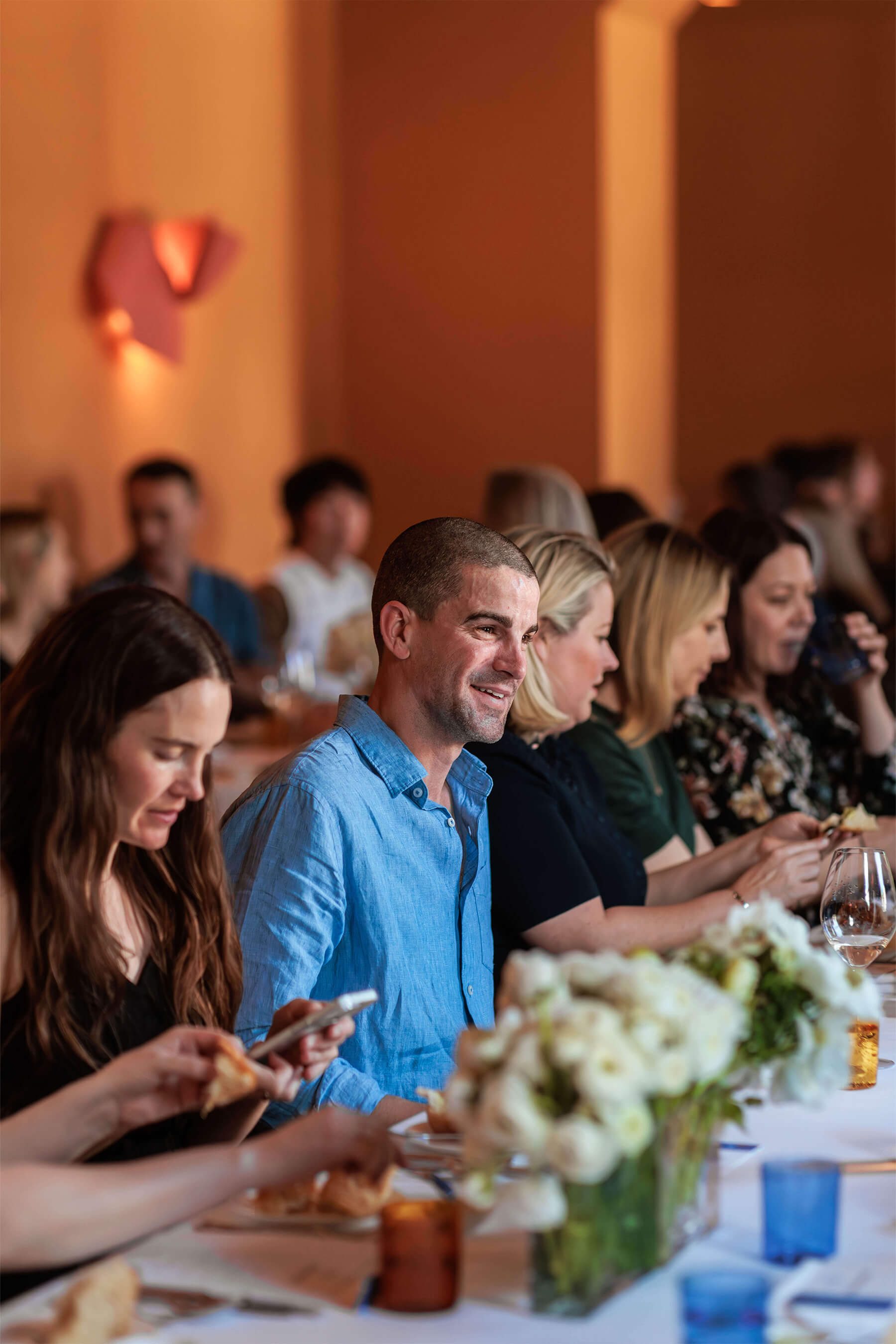 Guests seated along a long dining table, enjoying conversation and lunch at Ursula’s Paddington for the Royal Oak Floors product showcase.