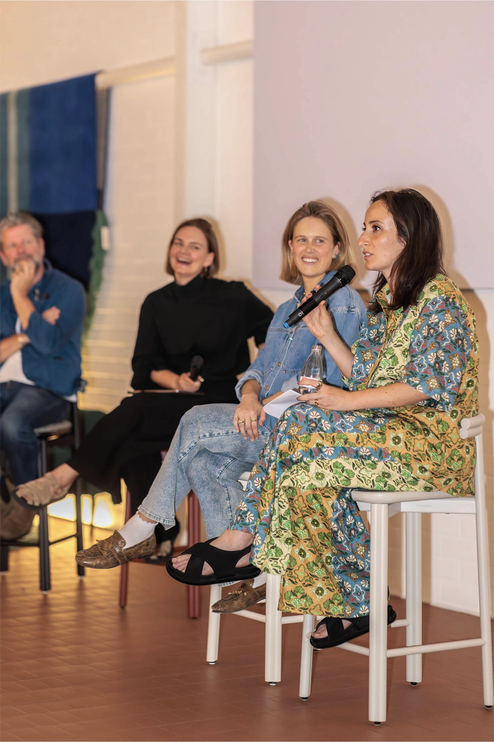 Panelists Eliza Gosse, Nasim Koerting, and Sarah Gibson speaking on stage during the DesignByThem “I’ll Be Happy When” event.