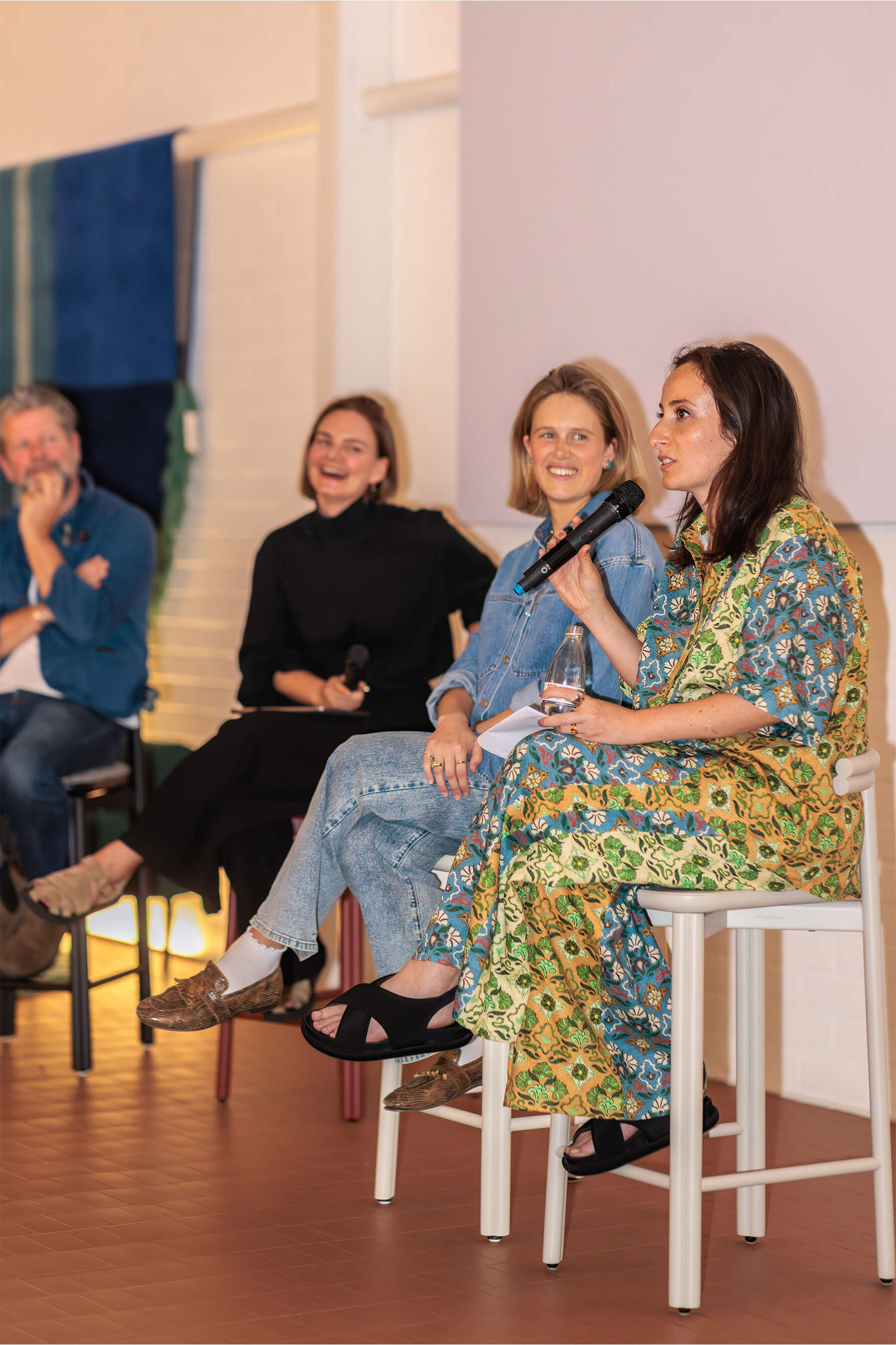 Panelists Eliza Gosse, Nasim Koerting, and Sarah Gibson speaking on stage during the DesignByThem “I’ll Be Happy When” event.
