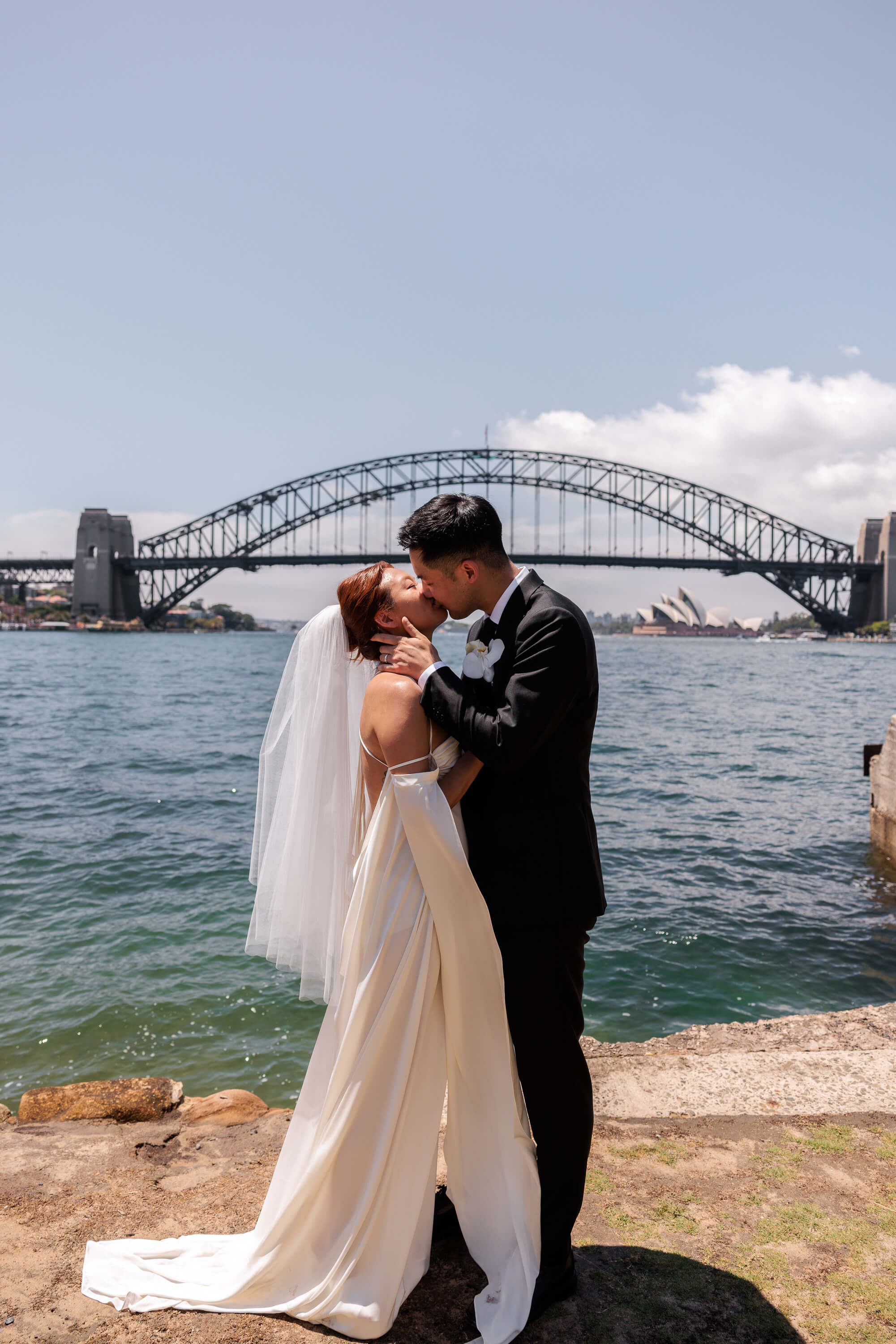 A close embrace between Melanie and Dai moments after their ceremony, capturing the joy of their wedding day by the harbour.