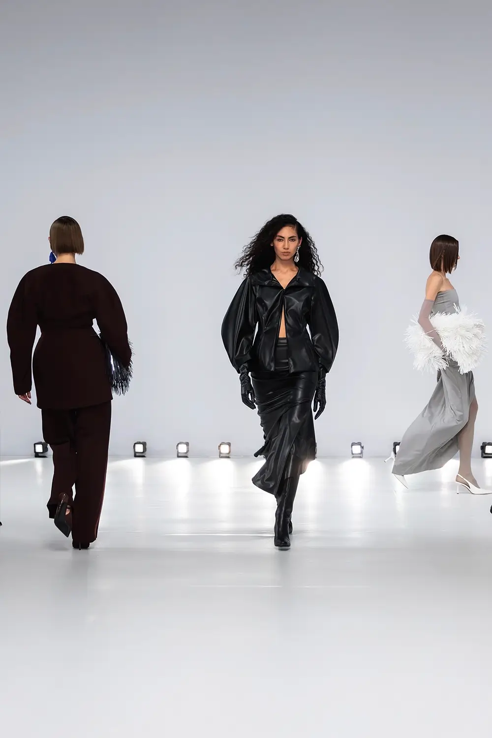 Mariam Seddiq ‘Echoes’ runway show photographed at Australian Fashion Week 2026, featuring sculptural silhouettes, elevated tailoring, leather detailing and contemporary Australian fashion captured in an editorial runway setting.