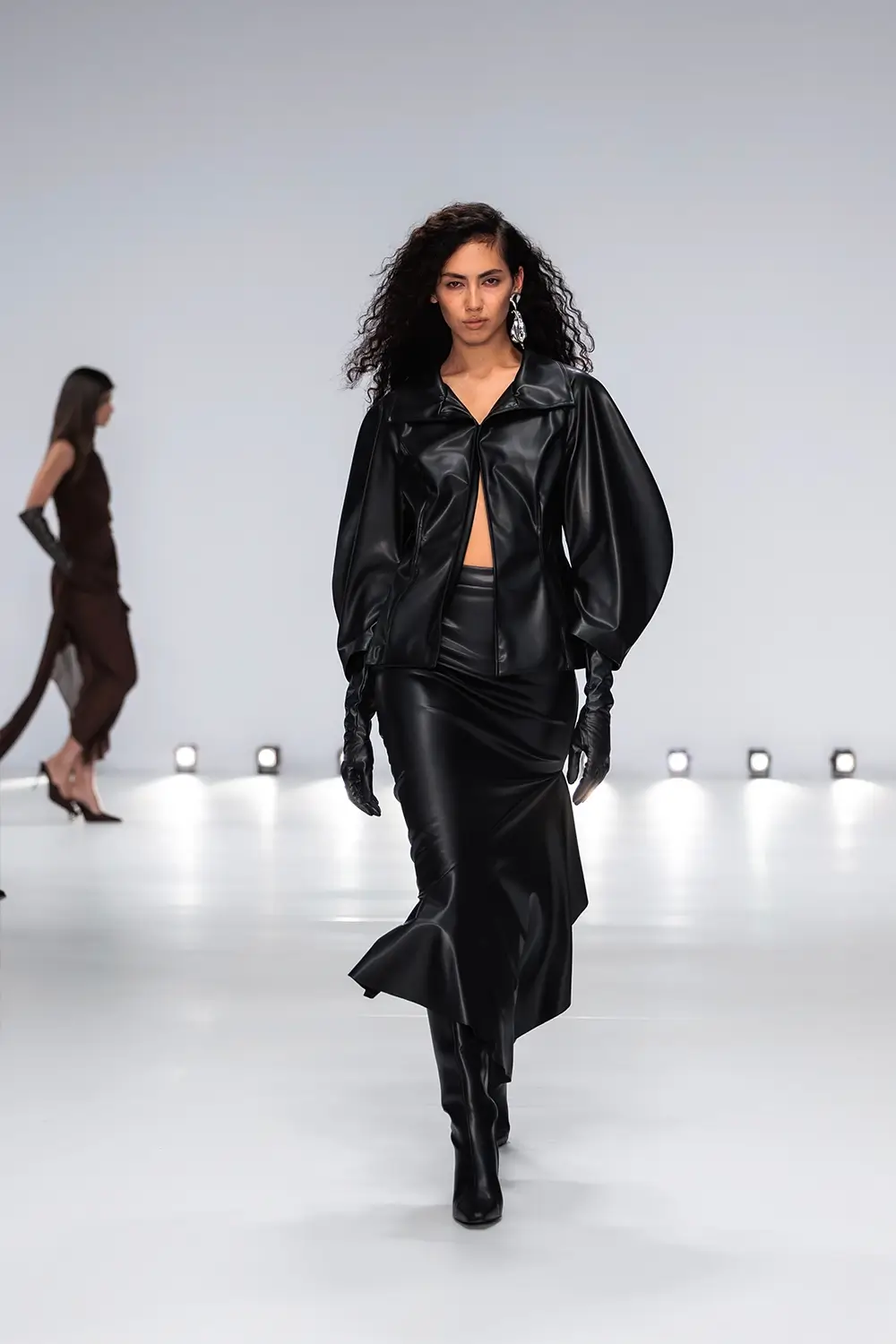 Mariam Seddiq ‘Echoes’ runway show photographed at Australian Fashion Week 2026, featuring sculptural silhouettes, elevated tailoring, leather detailing and contemporary Australian fashion captured in an editorial runway setting.