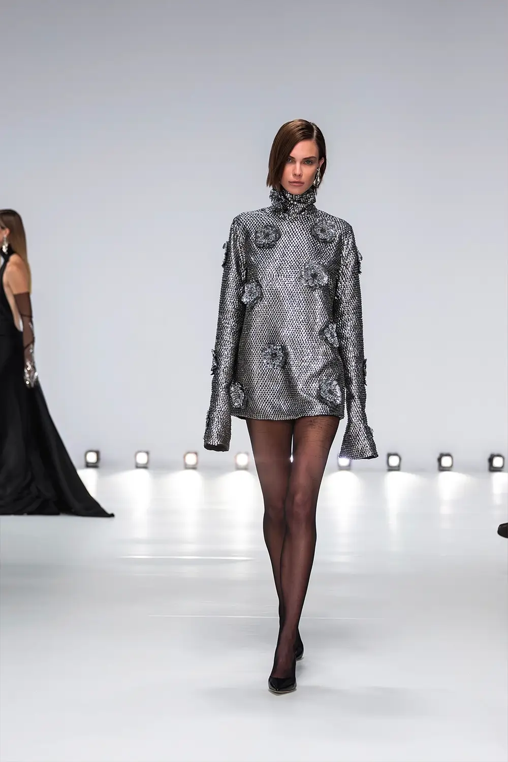 Mariam Seddiq ‘Echoes’ runway show photographed at Australian Fashion Week 2026, featuring sculptural silhouettes, elevated tailoring, leather detailing and contemporary Australian fashion captured in an editorial runway setting.