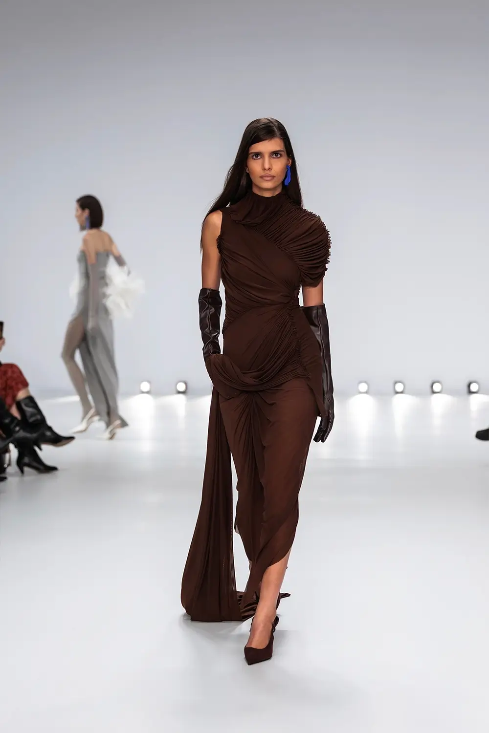 Mariam Seddiq ‘Echoes’ runway show photographed at Australian Fashion Week 2026, featuring sculptural silhouettes, elevated tailoring, leather detailing and contemporary Australian fashion captured in an editorial runway setting.
