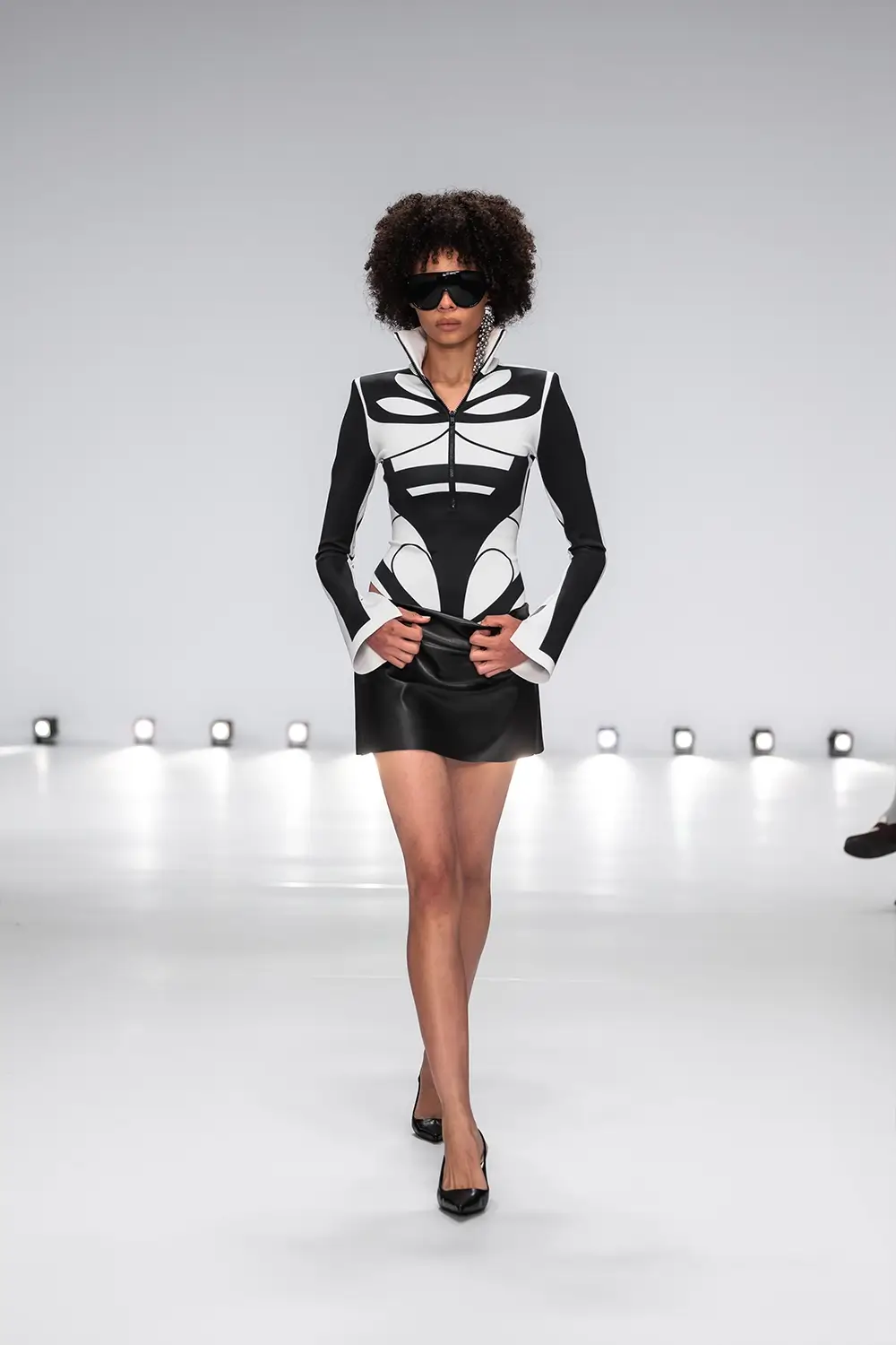 Mariam Seddiq ‘Echoes’ runway show photographed at Australian Fashion Week 2026, featuring sculptural silhouettes, elevated tailoring, leather detailing and contemporary Australian fashion captured in an editorial runway setting.