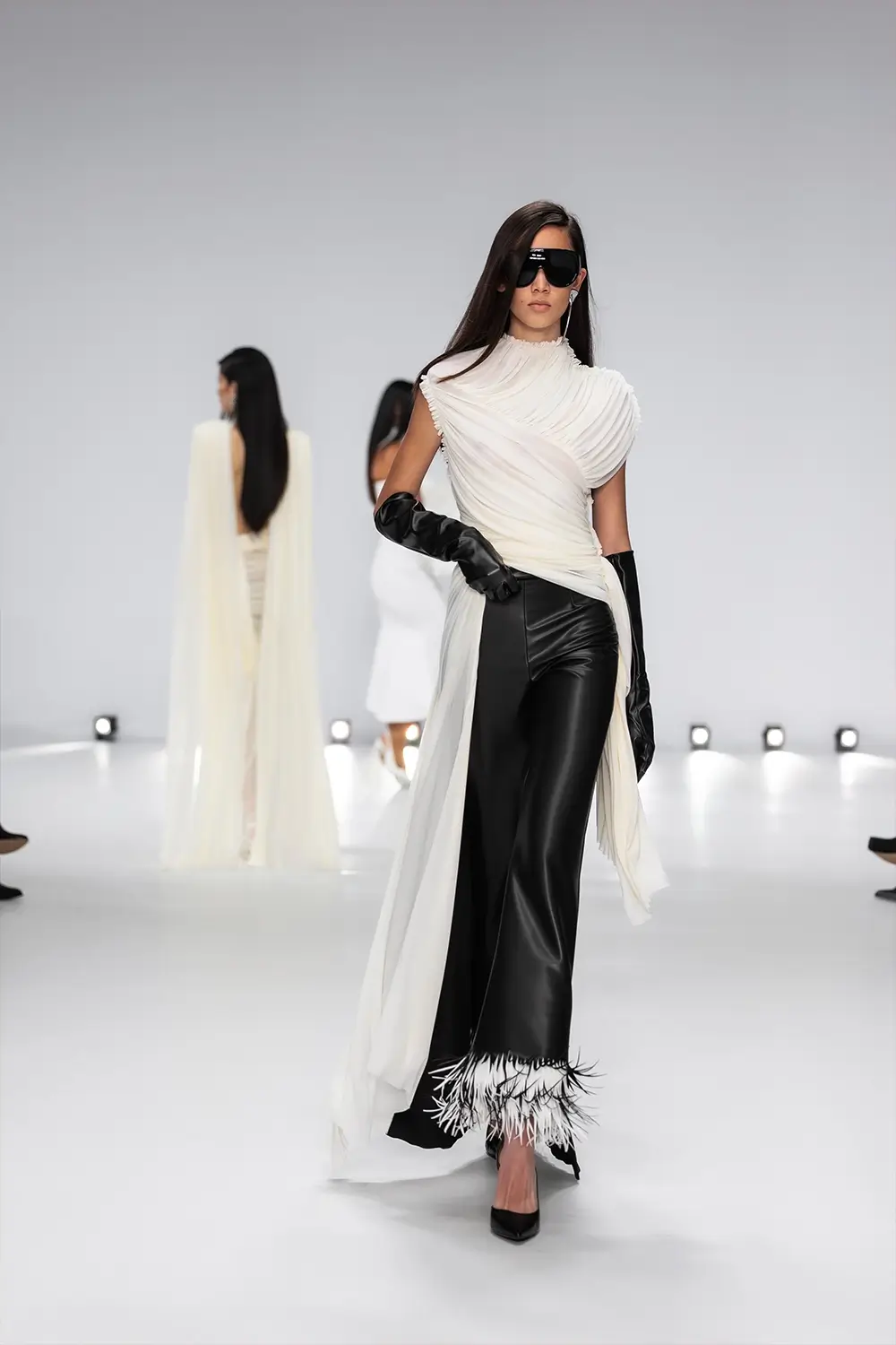 Mariam Seddiq ‘Echoes’ runway show photographed at Australian Fashion Week 2026, featuring sculptural silhouettes, elevated tailoring, leather detailing and contemporary Australian fashion captured in an editorial runway setting.