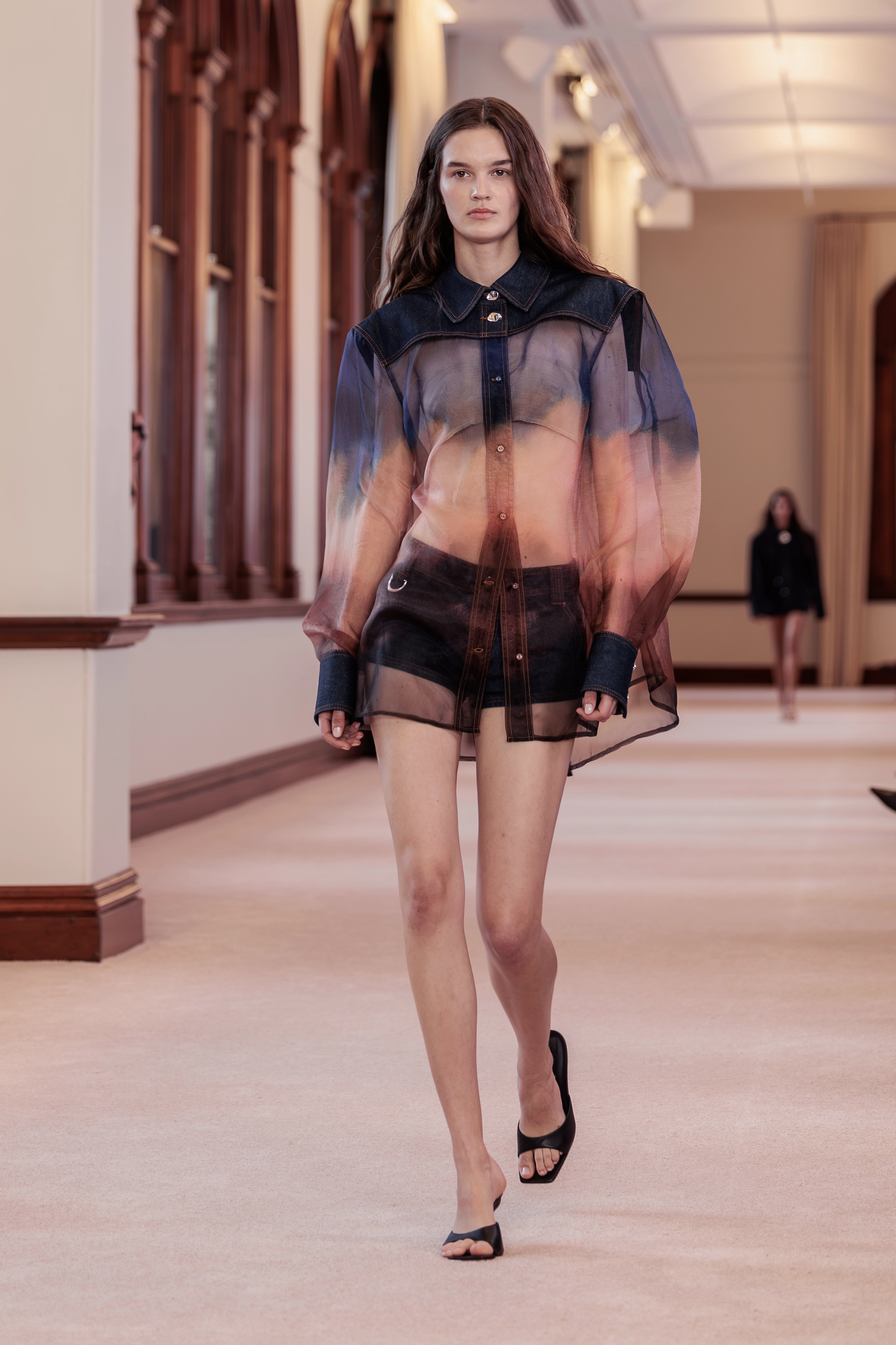 Aje. ‘Siren’ runway show photographed at Australian Fashion Week 2026 at The Lands by Capella Sydney, featuring sculptural resortwear, flowing silhouettes, artisanal textures and contemporary Australian fashion captured in an editorial runway setting.
