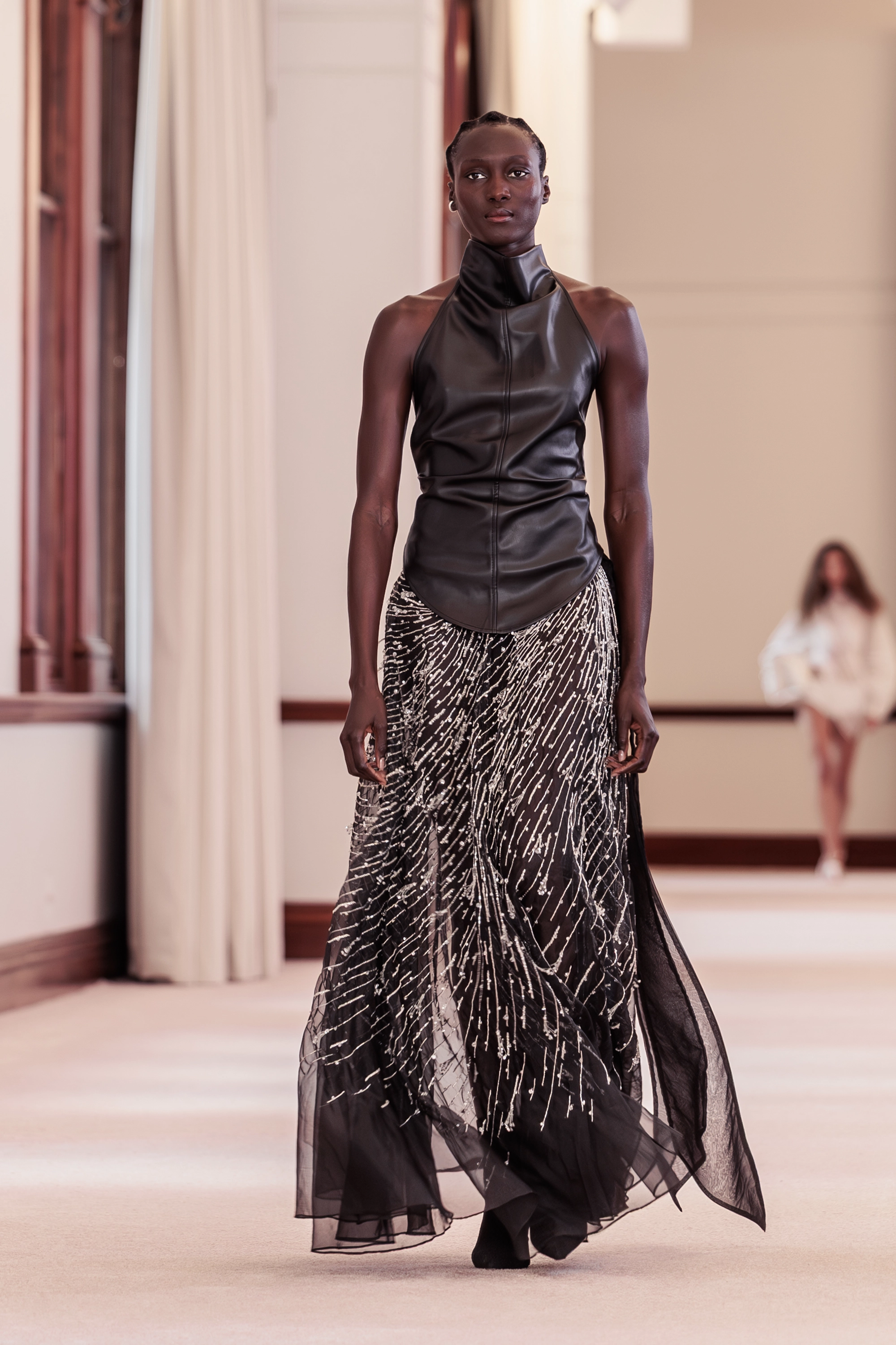 Aje. ‘Siren’ runway show photographed at Australian Fashion Week 2026 at The Lands by Capella Sydney, featuring sculptural resortwear, flowing silhouettes, artisanal textures and contemporary Australian fashion captured in an editorial runway setting.