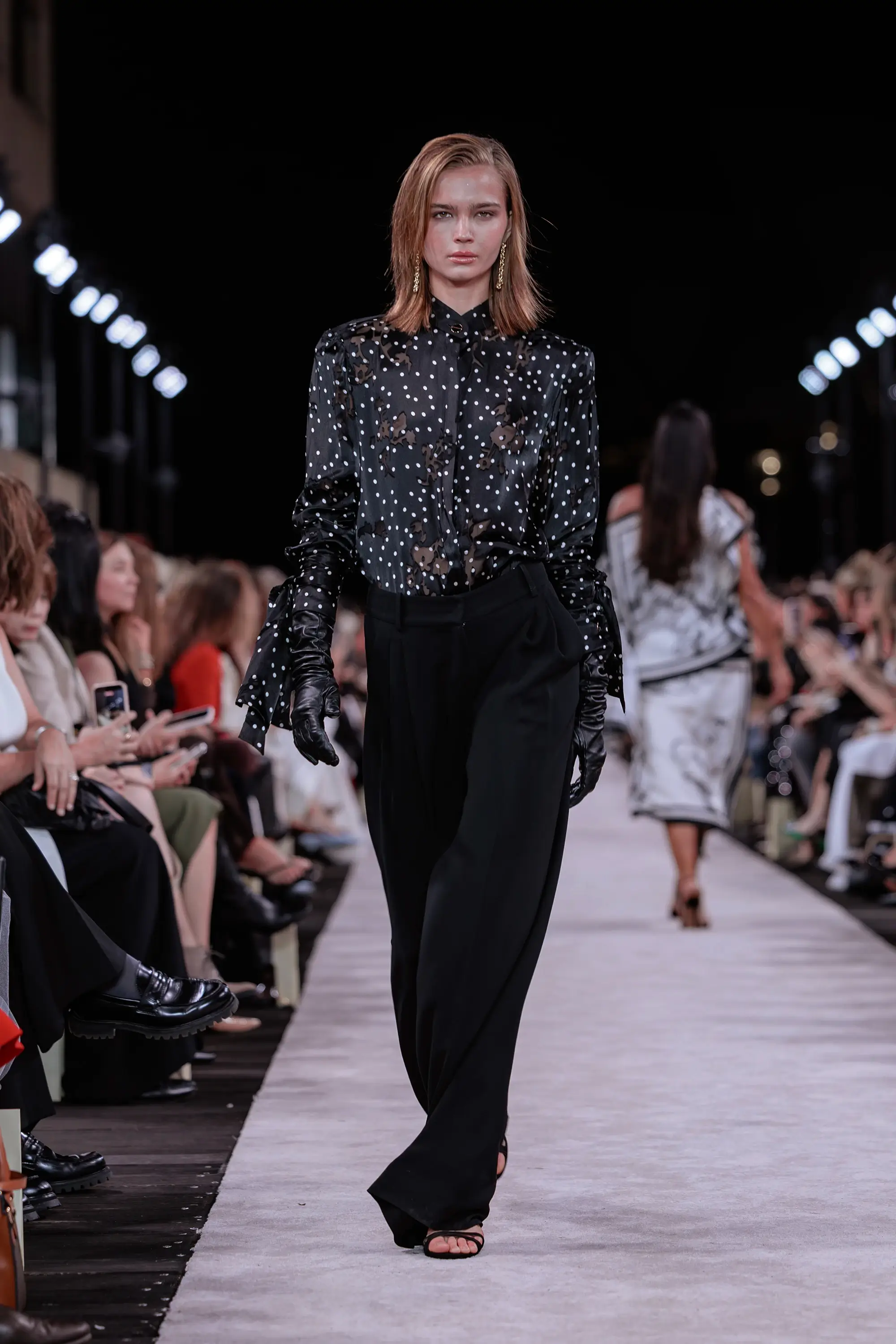 Carla Zampatti ‘Reflections’ runway show photographed at Australian Fashion Week 2026 at the Park Hyatt Sydney Boardwalk, featuring elevated tailoring, fluid silhouettes, shimmering eveningwear and contemporary Australian luxury fashion captured in an editorial runway setting.