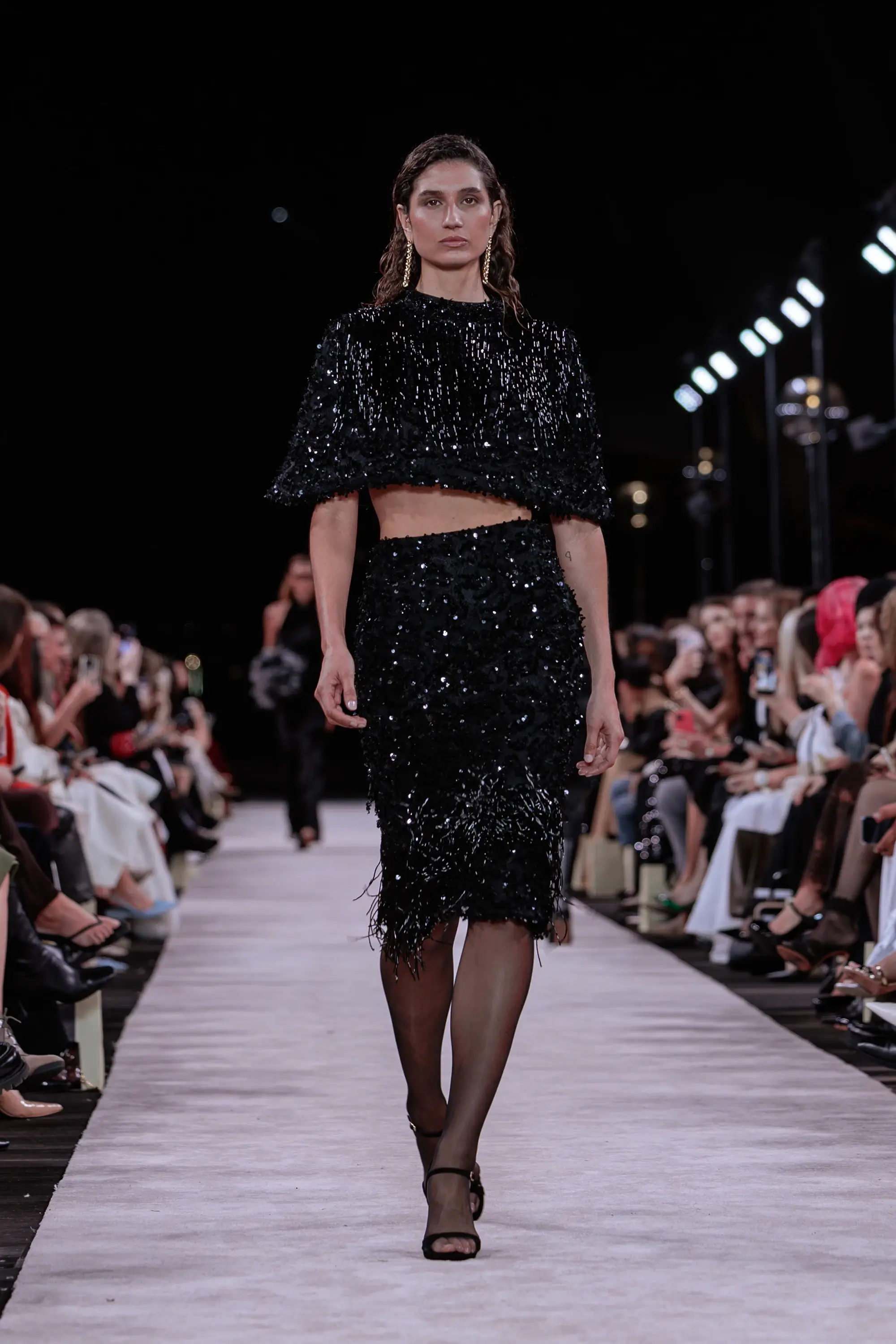 Carla Zampatti ‘Reflections’ runway show photographed at Australian Fashion Week 2026 at the Park Hyatt Sydney Boardwalk, featuring elevated tailoring, fluid silhouettes, shimmering eveningwear and contemporary Australian luxury fashion captured in an editorial runway setting.