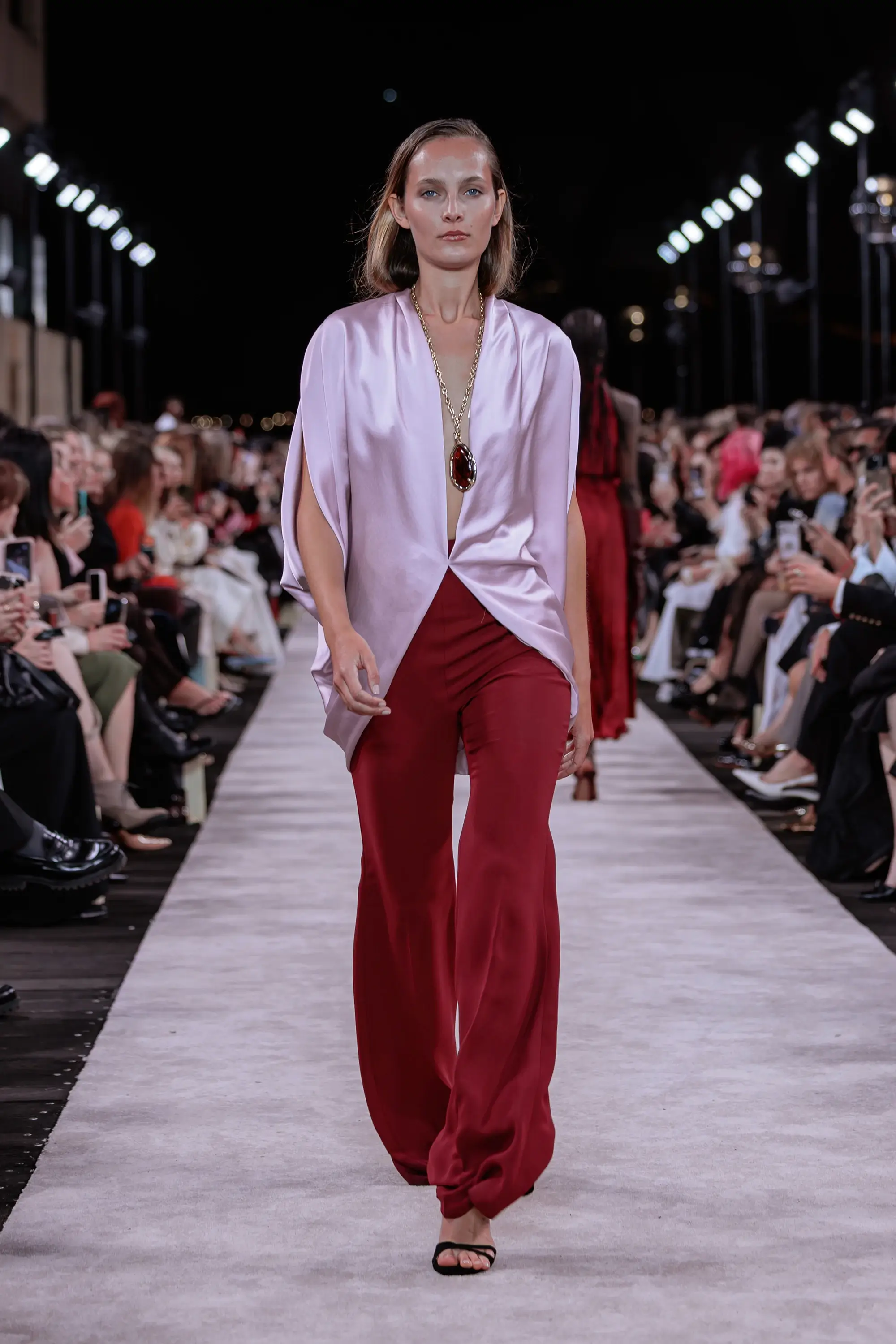 Carla Zampatti ‘Reflections’ runway show photographed at Australian Fashion Week 2026 at the Park Hyatt Sydney Boardwalk, featuring elevated tailoring, fluid silhouettes, shimmering eveningwear and contemporary Australian luxury fashion captured in an editorial runway setting.