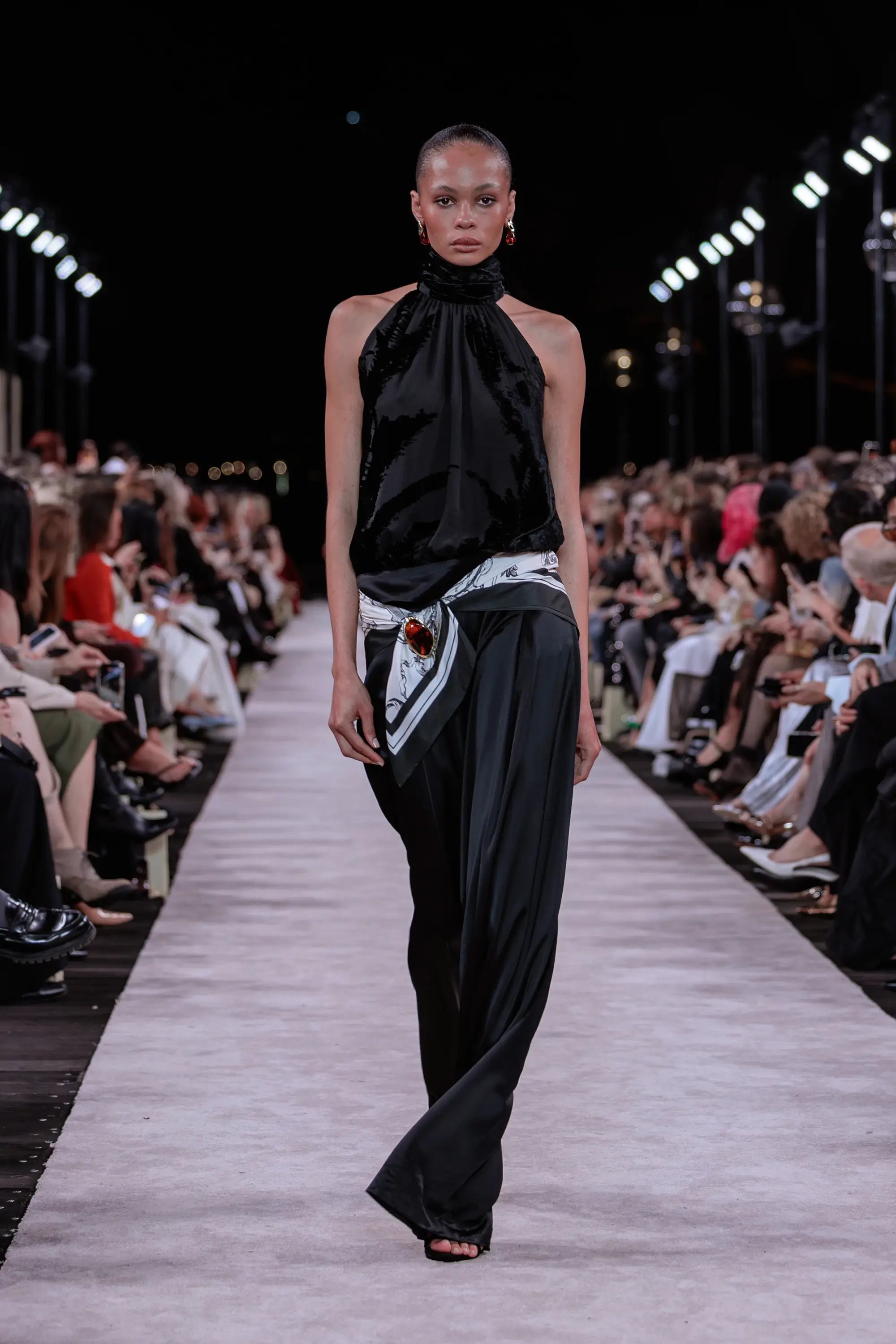 Carla Zampatti ‘Reflections’ runway show photographed at Australian Fashion Week 2026 at the Park Hyatt Sydney Boardwalk, featuring elevated tailoring, fluid silhouettes, shimmering eveningwear and contemporary Australian luxury fashion captured in an editorial runway setting.