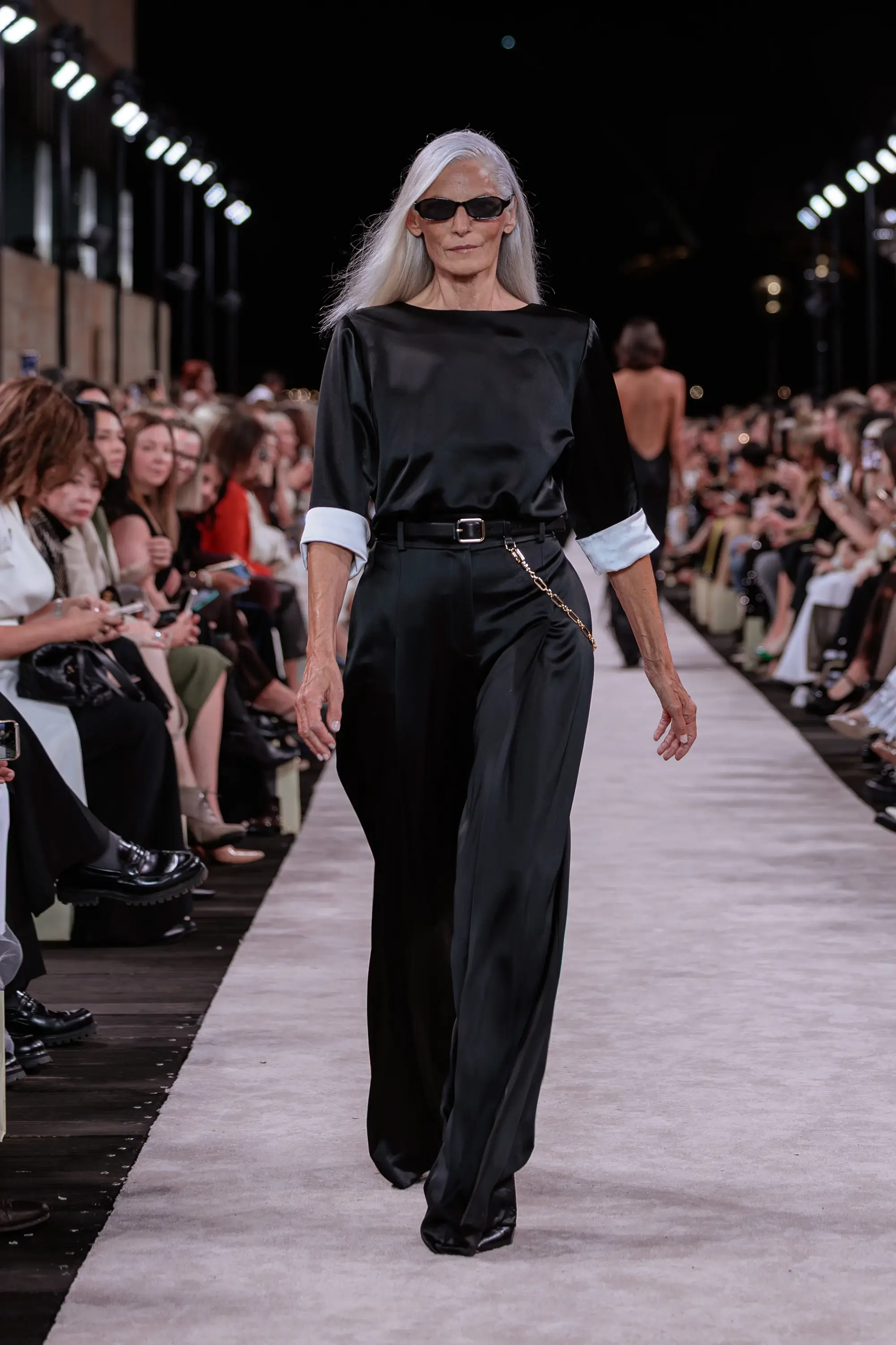 Carla Zampatti ‘Reflections’ runway show photographed at Australian Fashion Week 2026 at the Park Hyatt Sydney Boardwalk, featuring elevated tailoring, fluid silhouettes, shimmering eveningwear and contemporary Australian luxury fashion captured in an editorial runway setting.