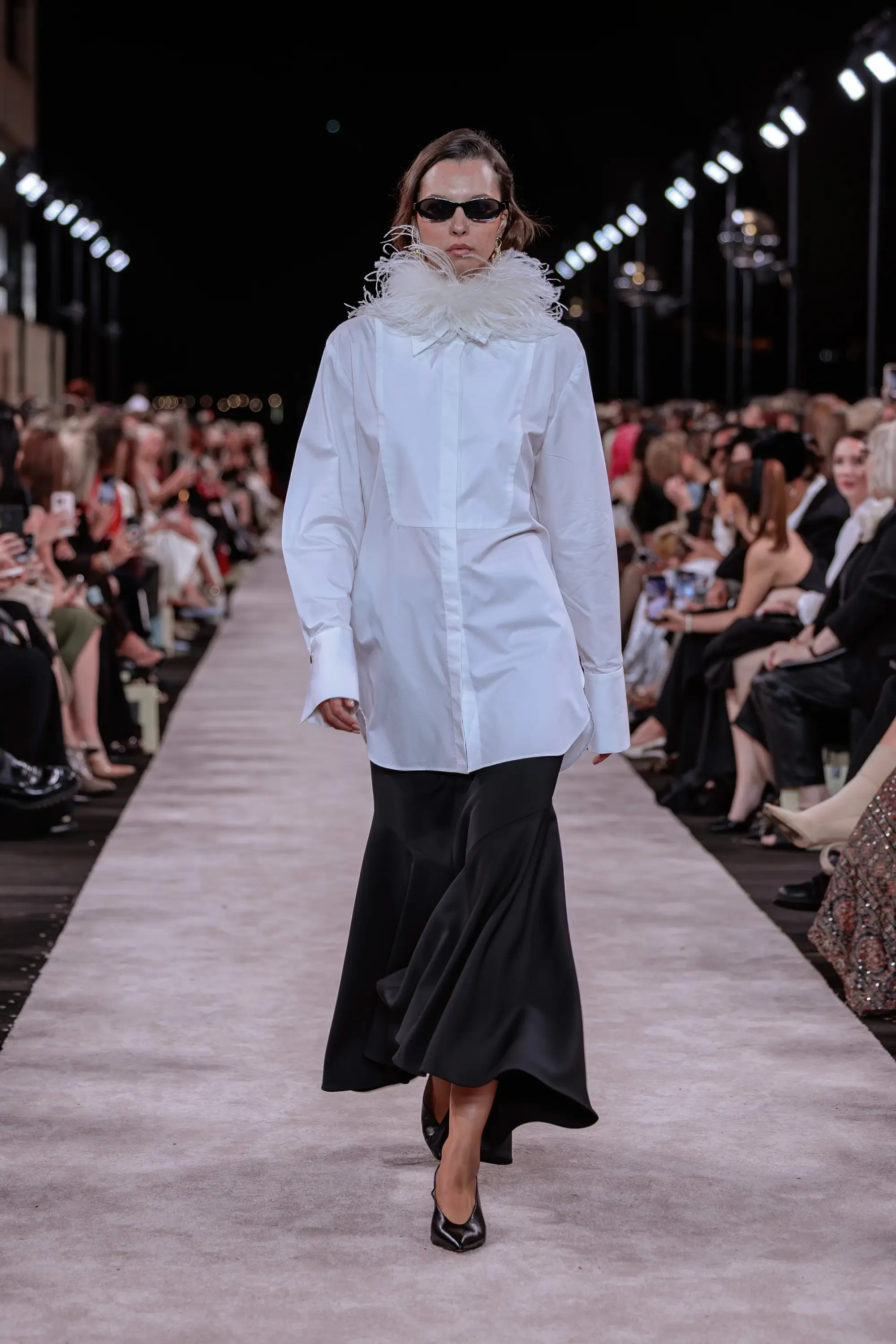 Carla Zampatti ‘Reflections’ runway show photographed at Australian Fashion Week 2026 at the Park Hyatt Sydney Boardwalk, featuring elevated tailoring, fluid silhouettes, shimmering eveningwear and contemporary Australian luxury fashion captured in an editorial runway setting.