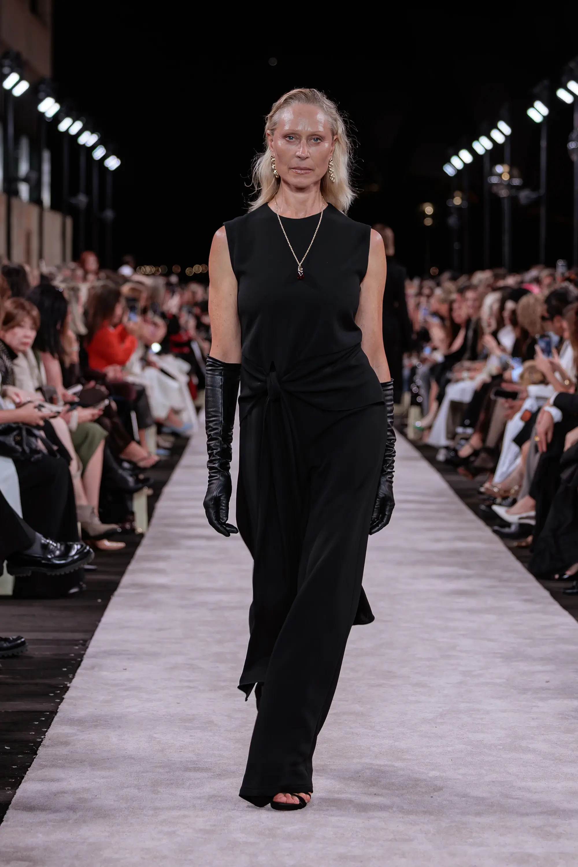 Carla Zampatti ‘Reflections’ runway show photographed at Australian Fashion Week 2026 at the Park Hyatt Sydney Boardwalk, featuring elevated tailoring, fluid silhouettes, shimmering eveningwear and contemporary Australian luxury fashion captured in an editorial runway setting.