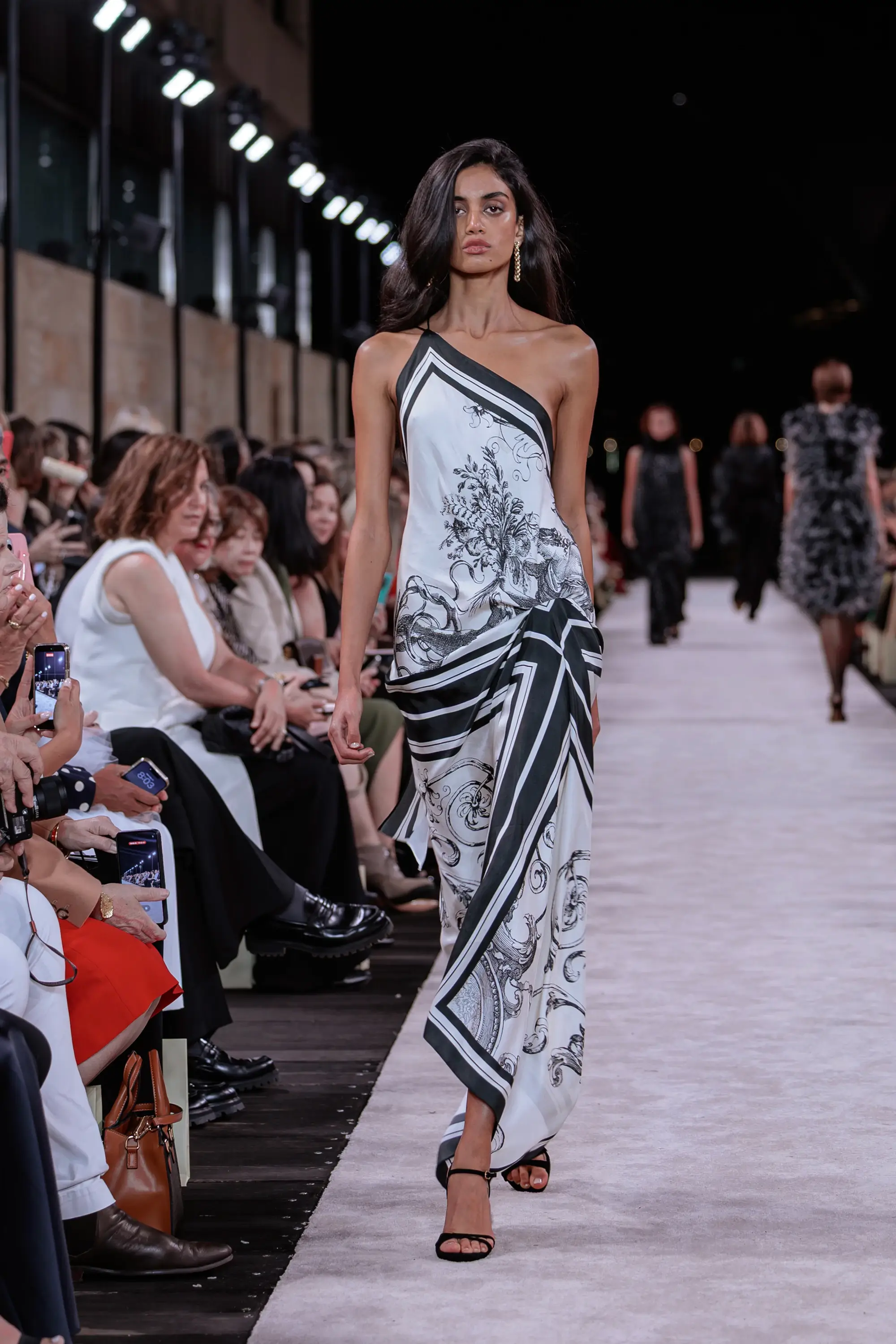 Carla Zampatti ‘Reflections’ runway show photographed at Australian Fashion Week 2026 at the Park Hyatt Sydney Boardwalk, featuring elevated tailoring, fluid silhouettes, shimmering eveningwear and contemporary Australian luxury fashion captured in an editorial runway setting.