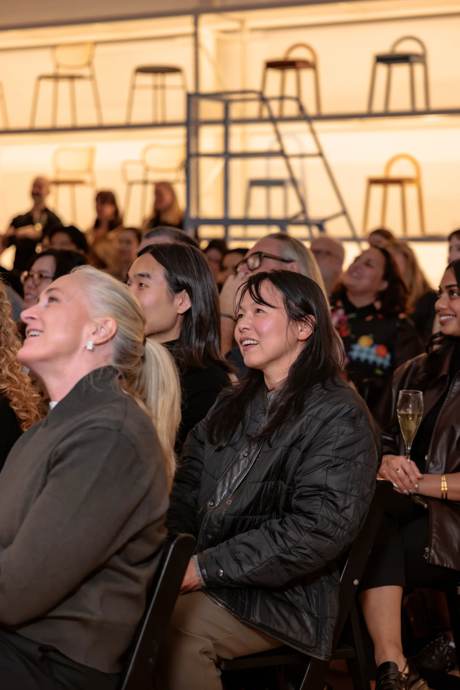 Audience members laughing during the I'll Be Happy When panel discussion, photographed by EDG Studios.