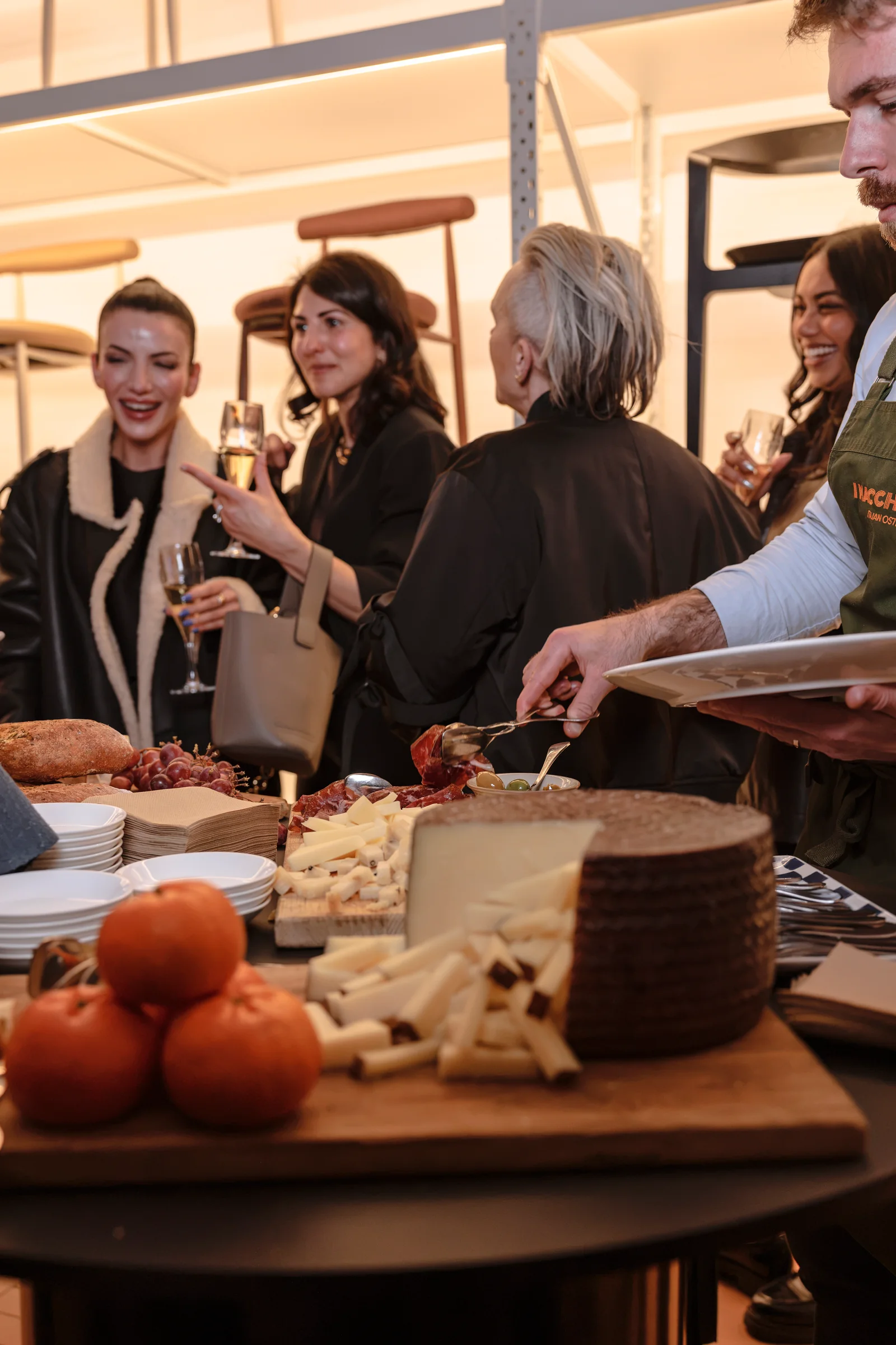 Guests serving themselves from sharing platters at Design By Them, photographed by EDG Studios.