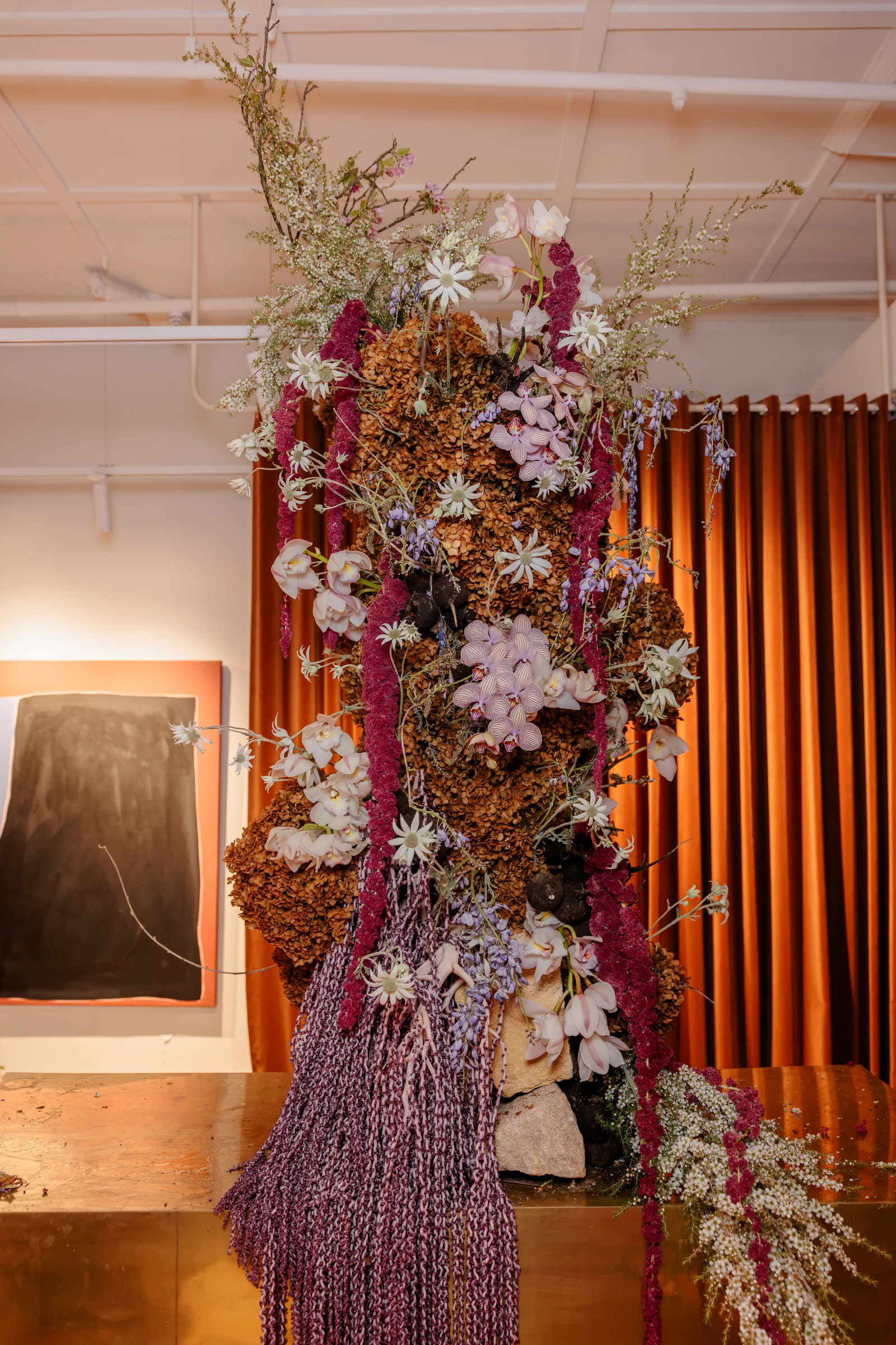 Sculptural floral installation against timber battens at Made By Storey, photographed by EDG Studios.