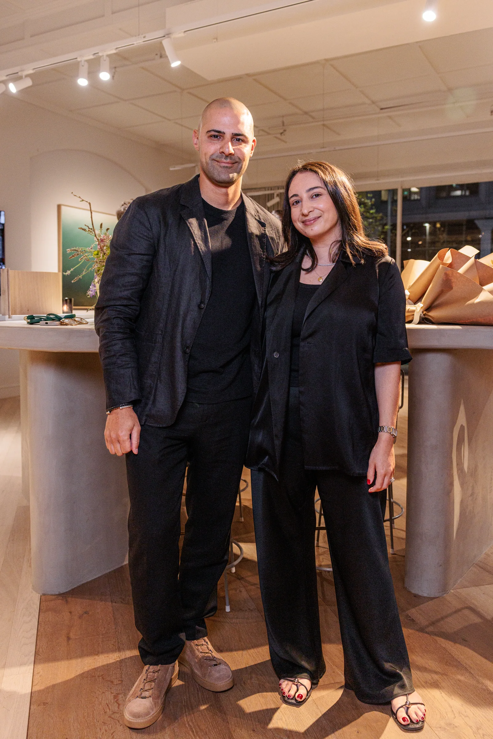 Two guests smiling together in the Made By Storey showroom, photographed by EDG Studios.